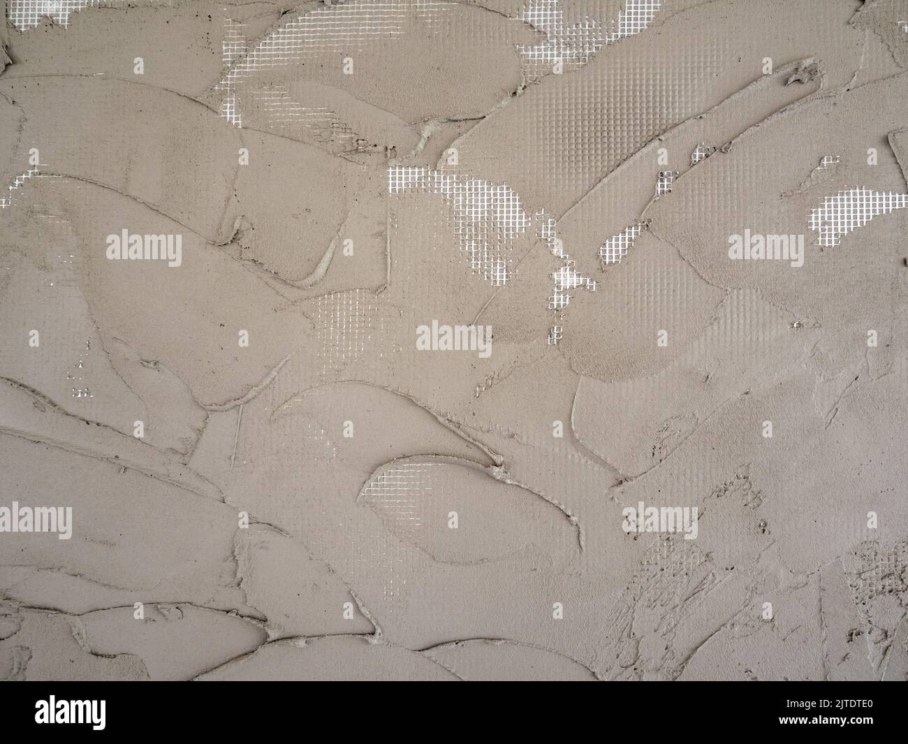 Plastering cement on a reinforcing plastic grid on a foam board Stock