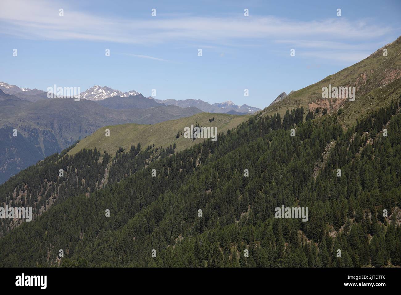 An aerial view of green mountain forests under blue cloudy sky Stock ...