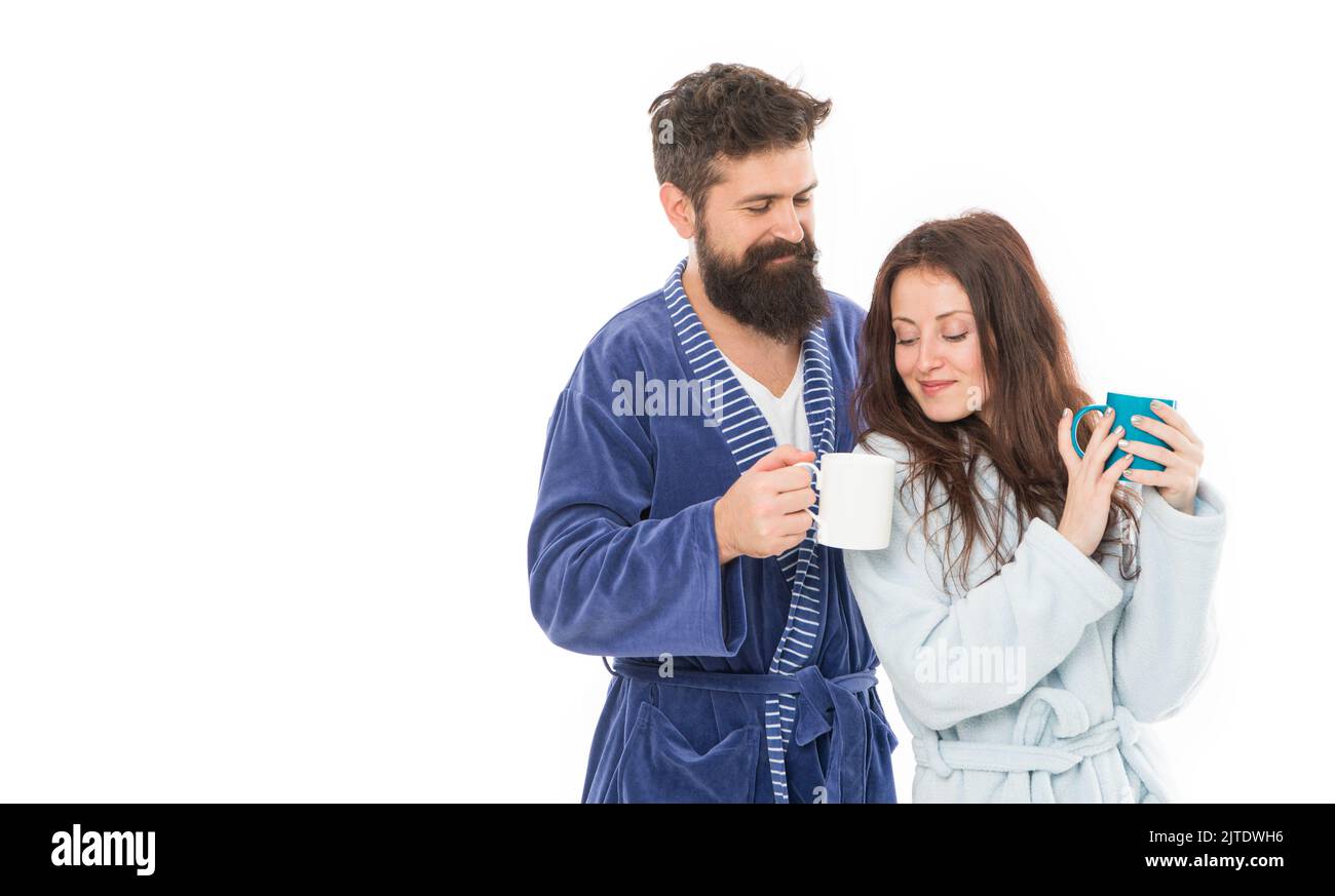 Man and woman wear bathrobes hold tea mug or coffee cup. Caffeine power