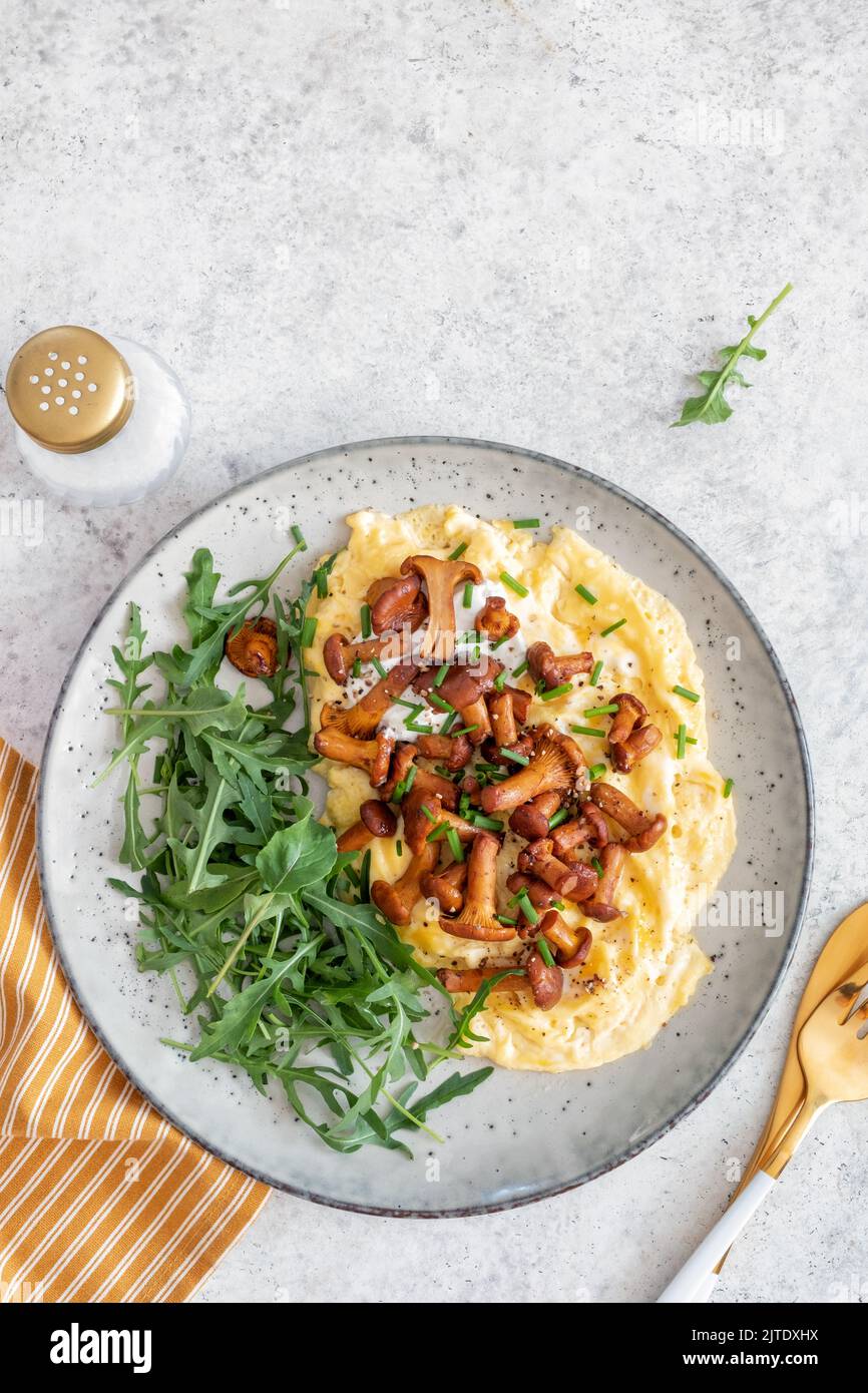 Traditional scrambled eggs with fresh chanterelle Stock Photo