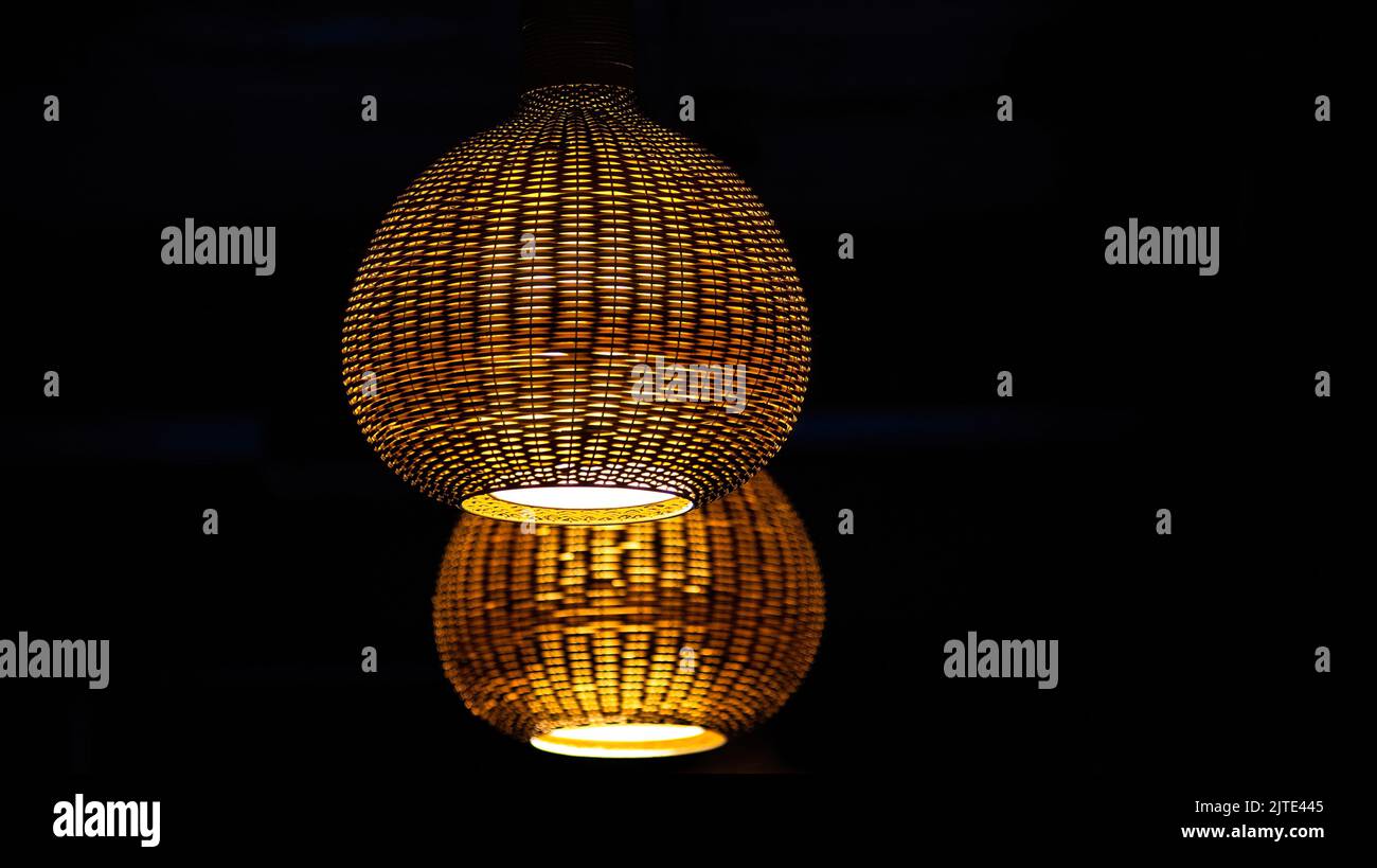 Modern hanging lighting fixtures. Two chandeliers made of wood. Light