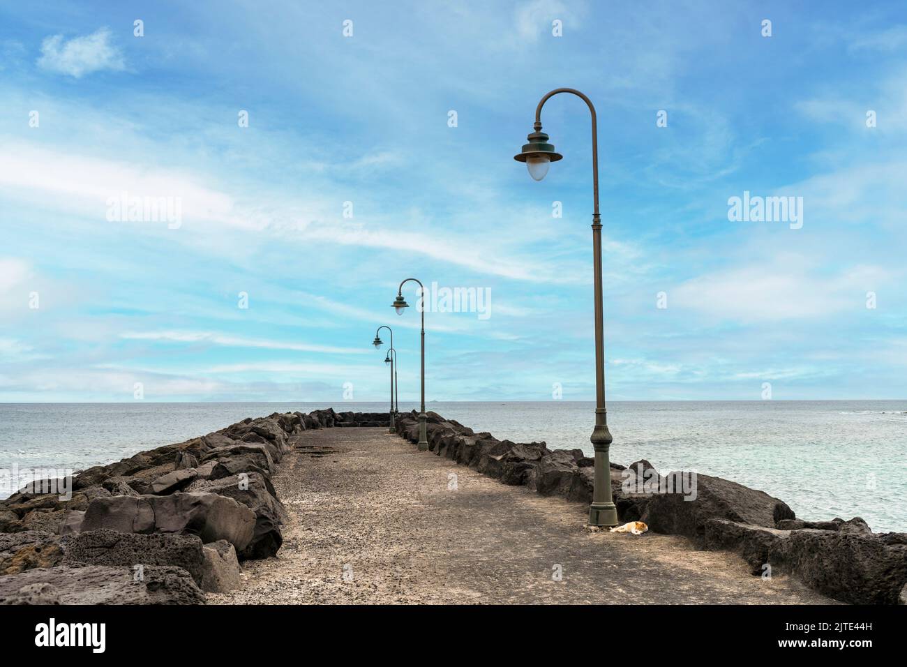Minimalistic pier with lanterns in Costa Teguise in Lanzarote, Canary Island, Spain Stock Photo