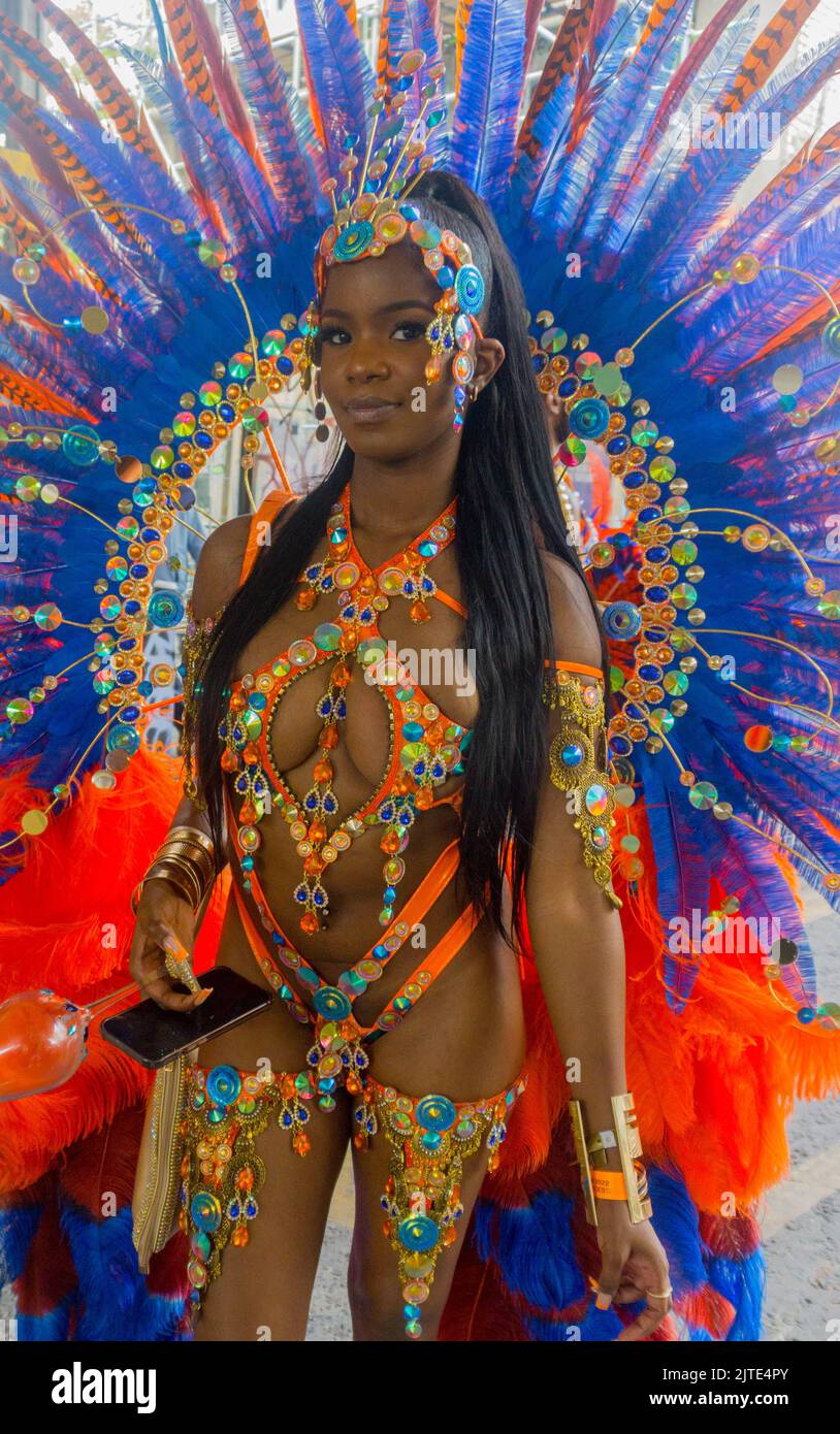 Londoners and tourists alike enjoy the last day of Notting Hill Carnival 2022. Participants dress in colourful costumes celebrating this year's event. Stock Photo