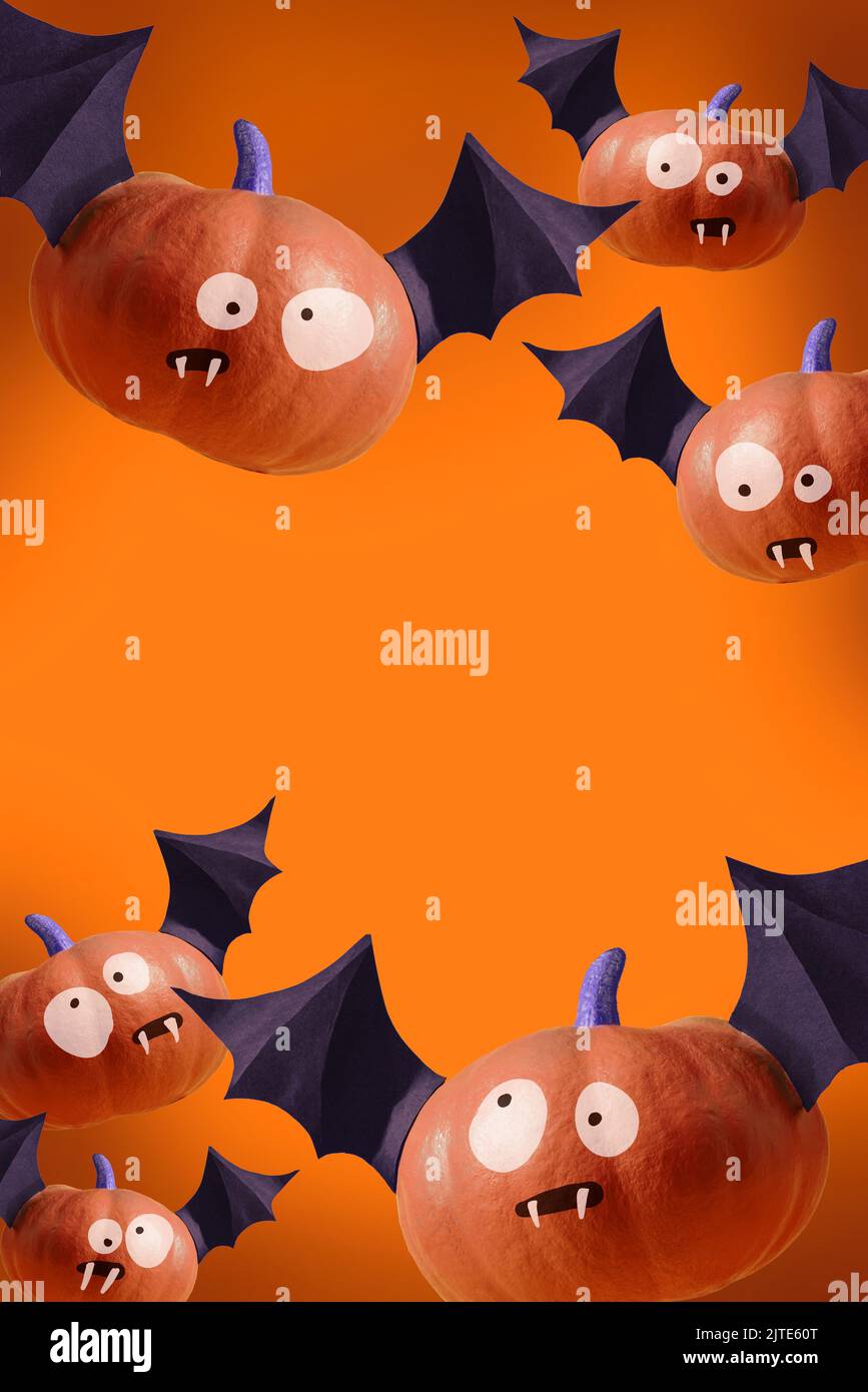Happy Halloween poster, orange party invitation background with pumpkins with bat wings with evil grimaces and vampire teeth. Modern orange Halloween Stock Photo