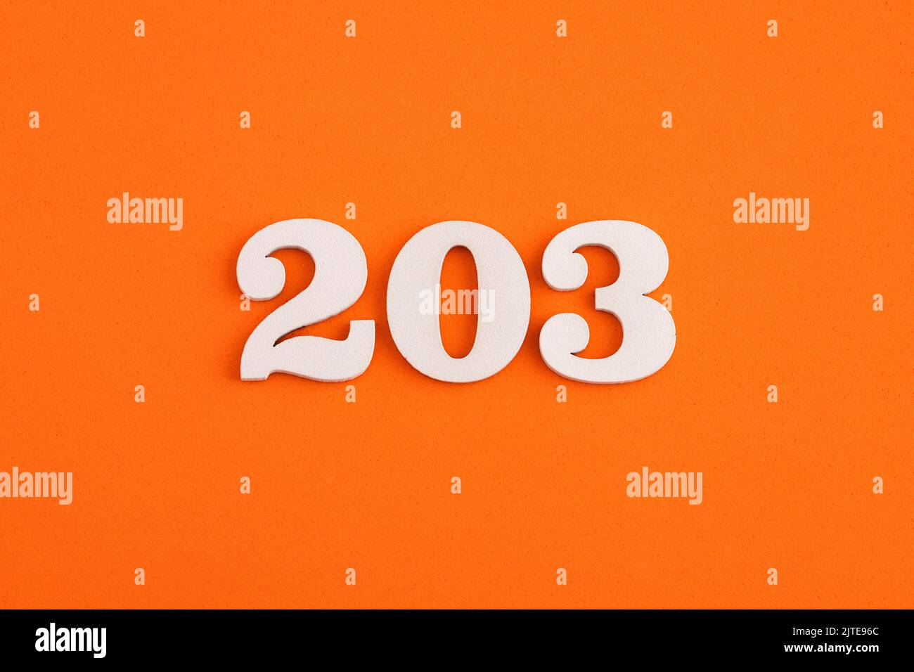 Number 203 - On orange foam rubber background Stock Photo