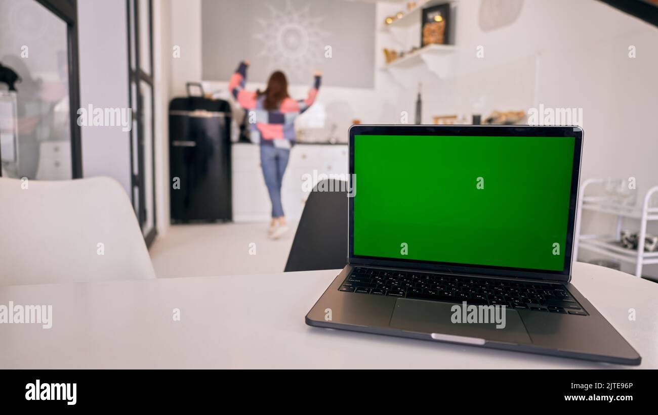 A closeup of notebook with green screen chroma key background on table Stock Photo