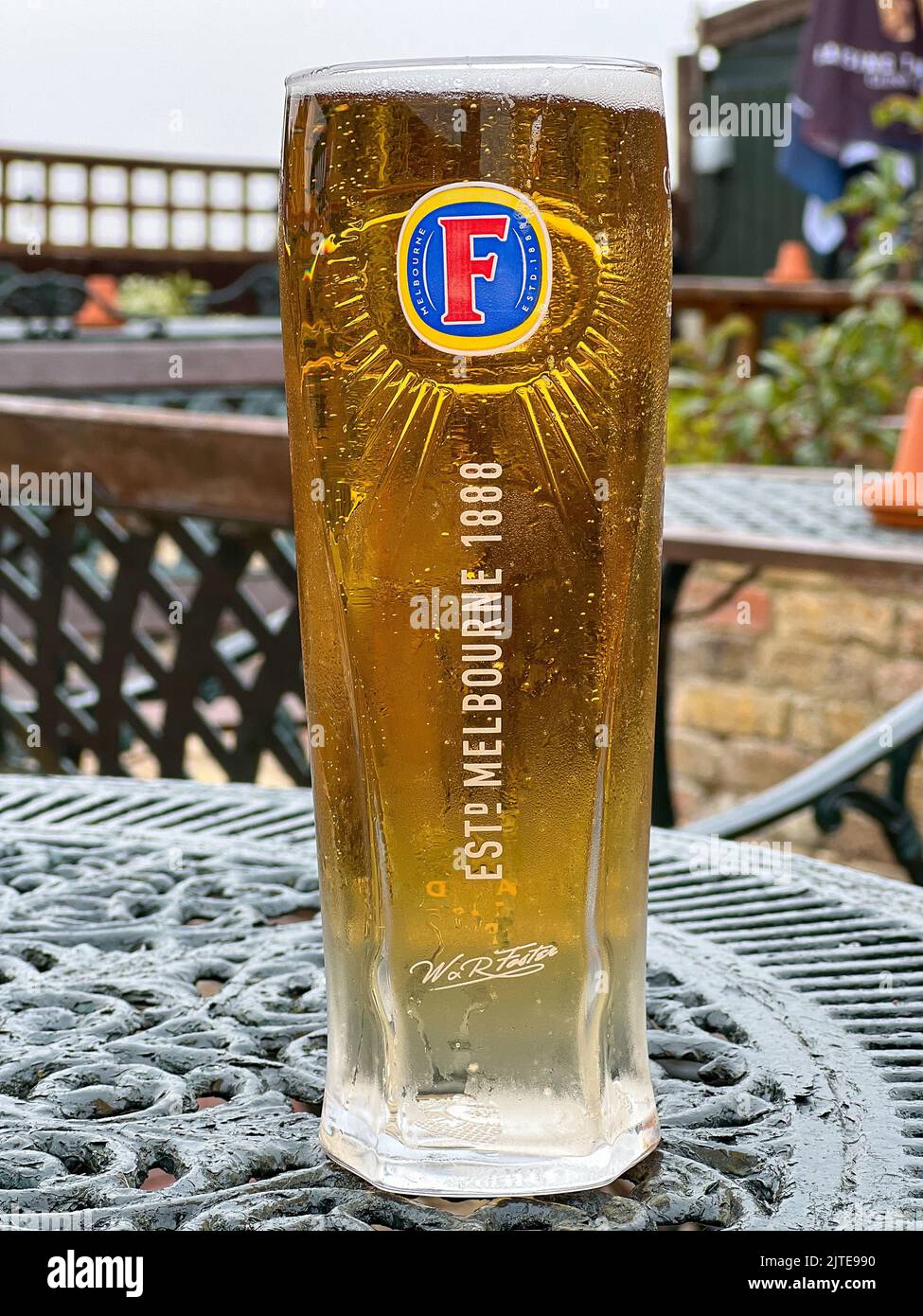 Folkestone, England - August 16, 2022: A pint of ice cold Fosters lager, a 4% ABV lager originating from Australia. In Europe it is brewed and distrib Stock Photo