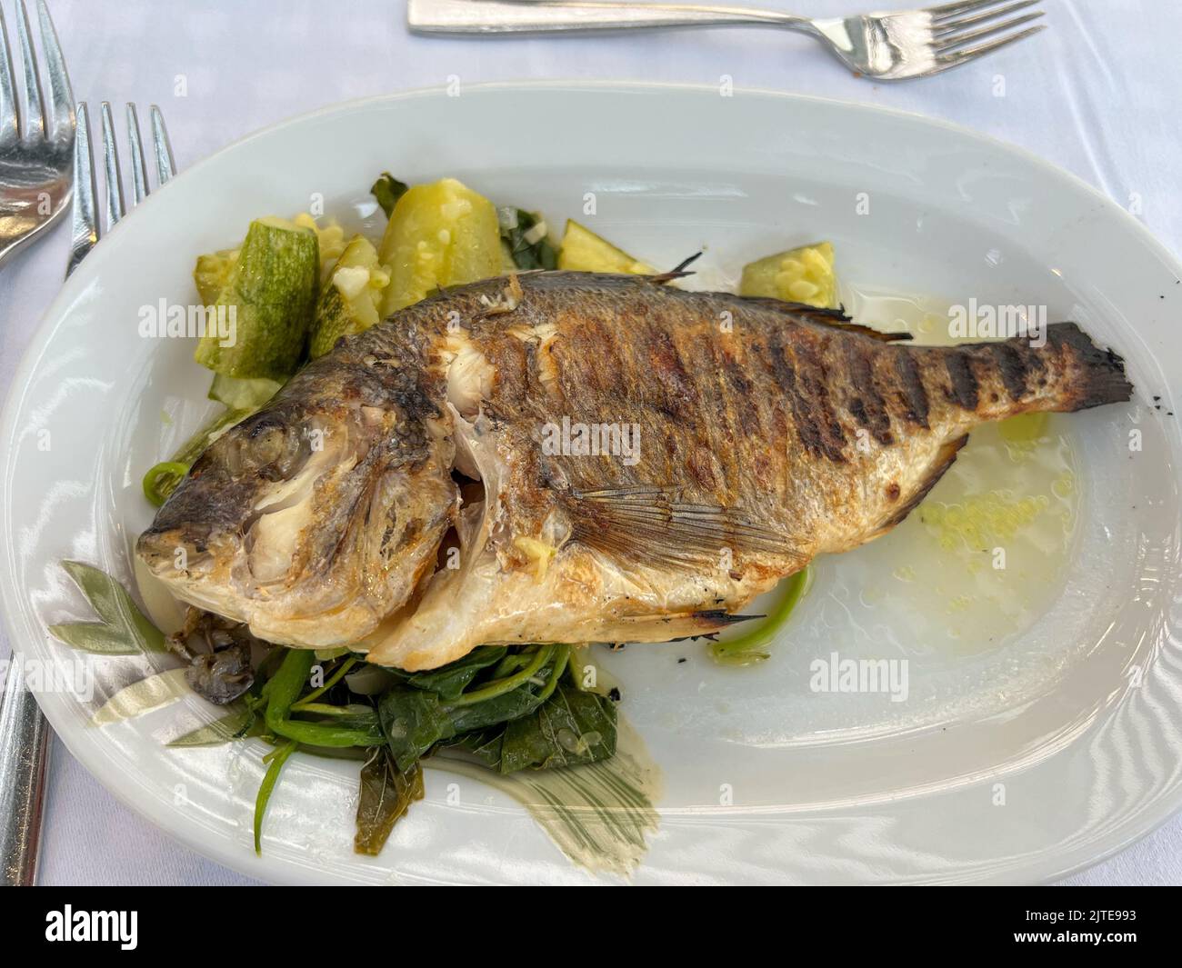 Grilled sea bass served with vegetables Stock Photo