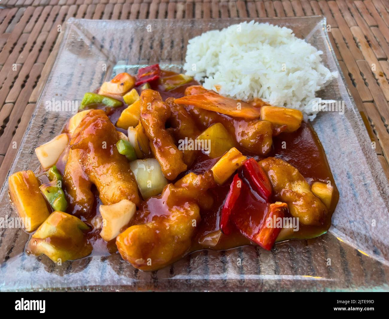 Chinese sweet and sour chicken with sticky white rice Stock Photo