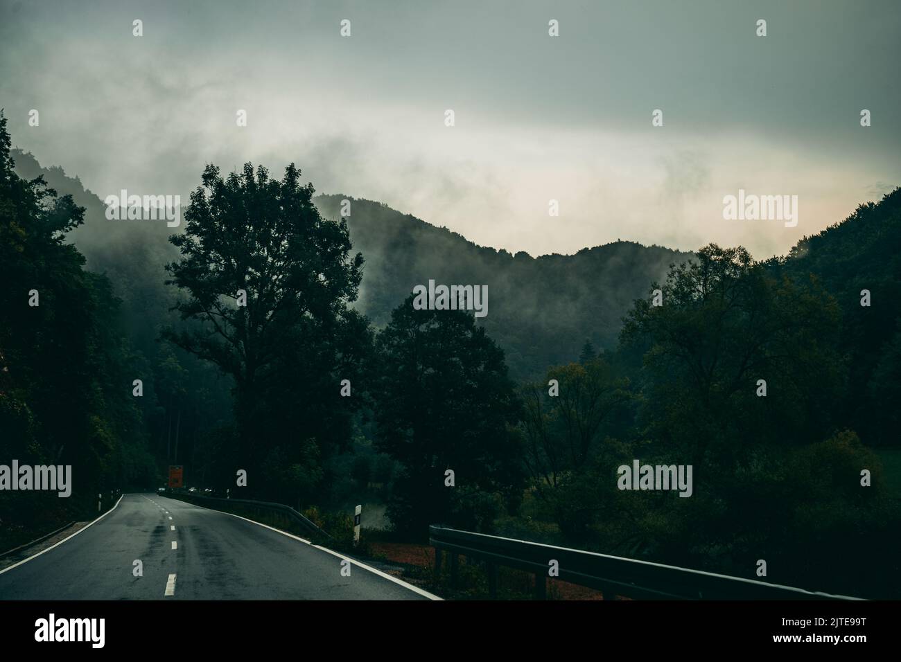 The countryside road passing through the forests of mountains on a ...