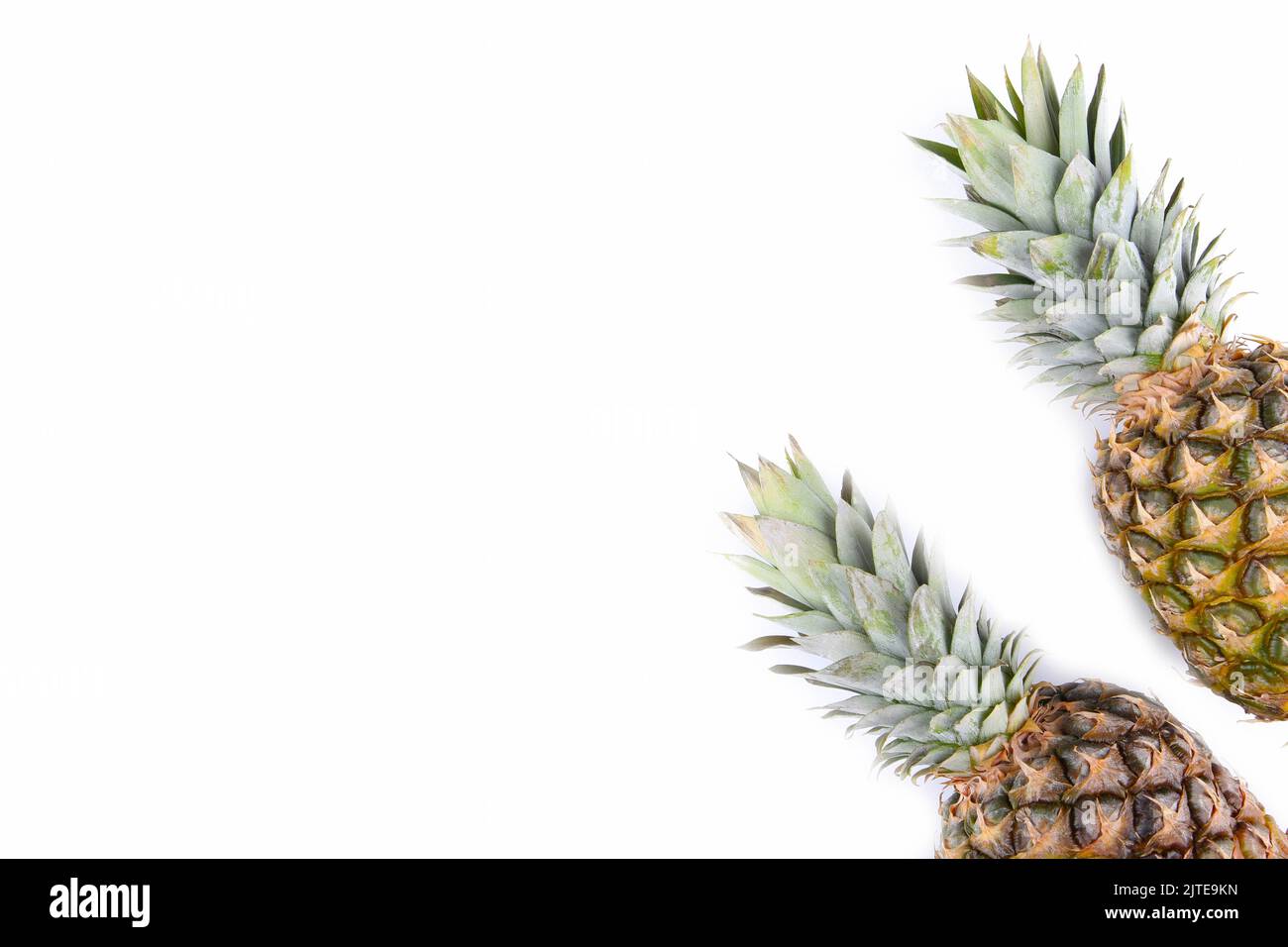 Two whole pineapples isolated on white background Stock Photo