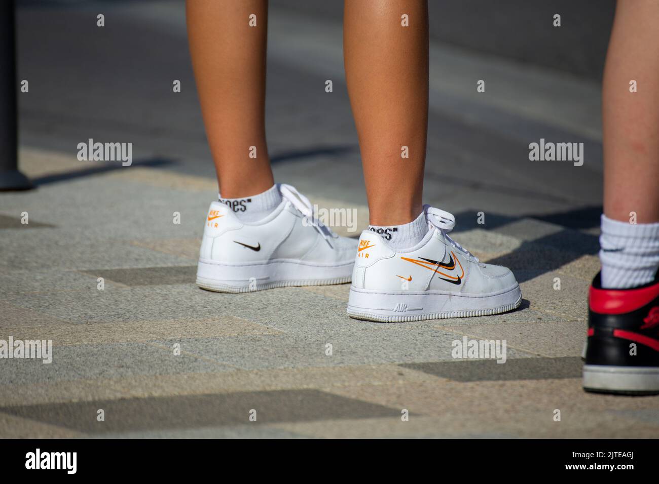 Young woman wears LIFESTYLE AIR FORCE 1 sneakers by Nike Stock Photo