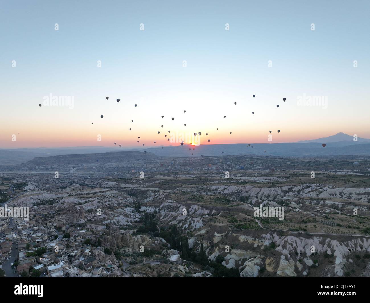 Aerial cinematic drone view of colorful hot air balloon flying over ...