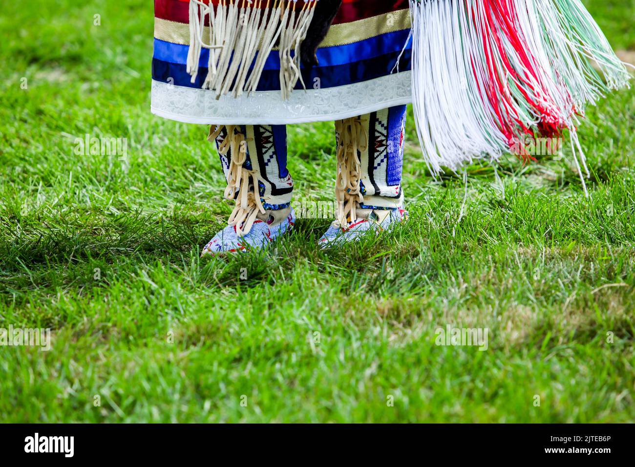 Close up from native American  dancer moccasins on grass with copy space Stock Photo