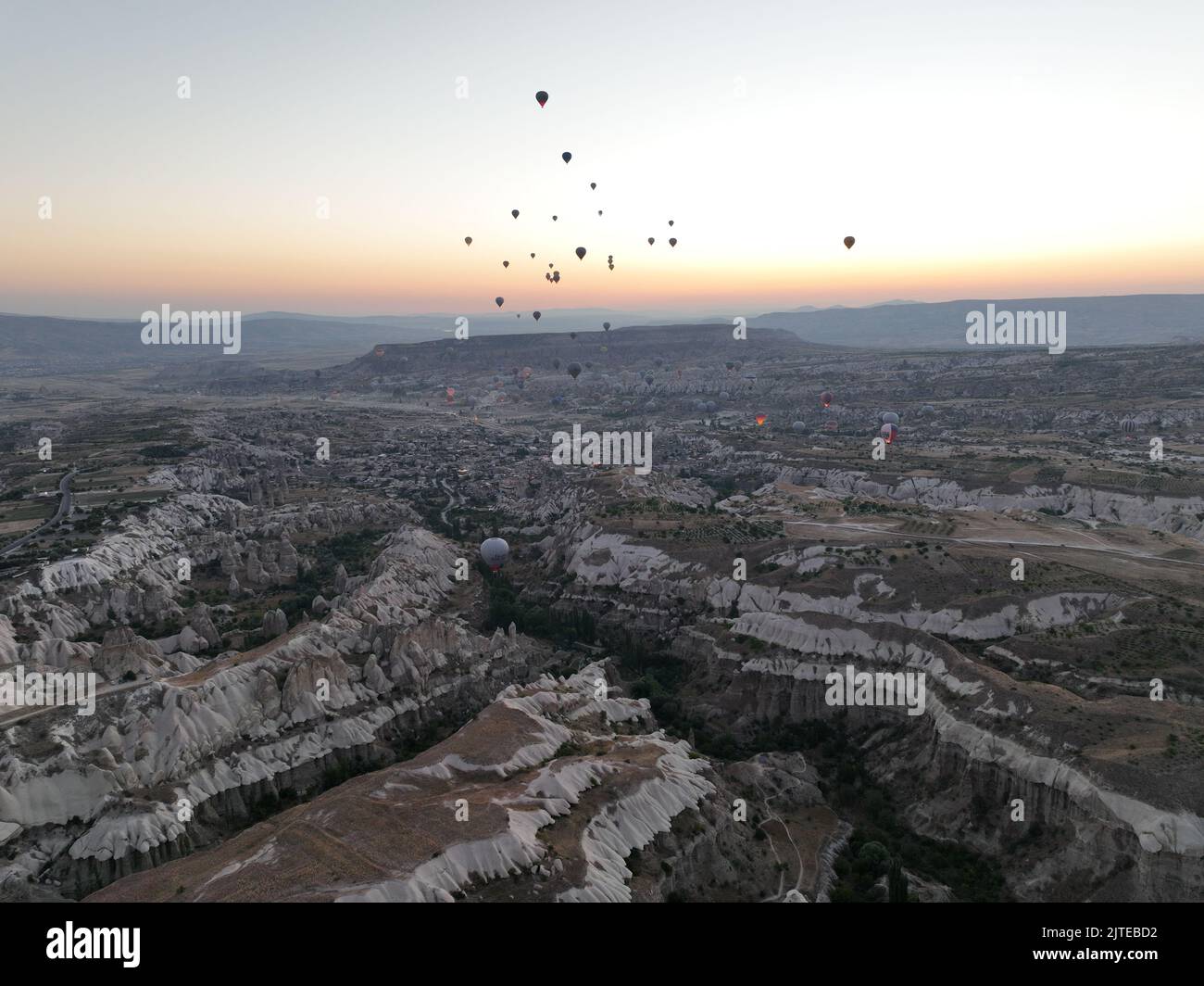 Aerial cinematic drone view of colorful hot air balloon flying over ...