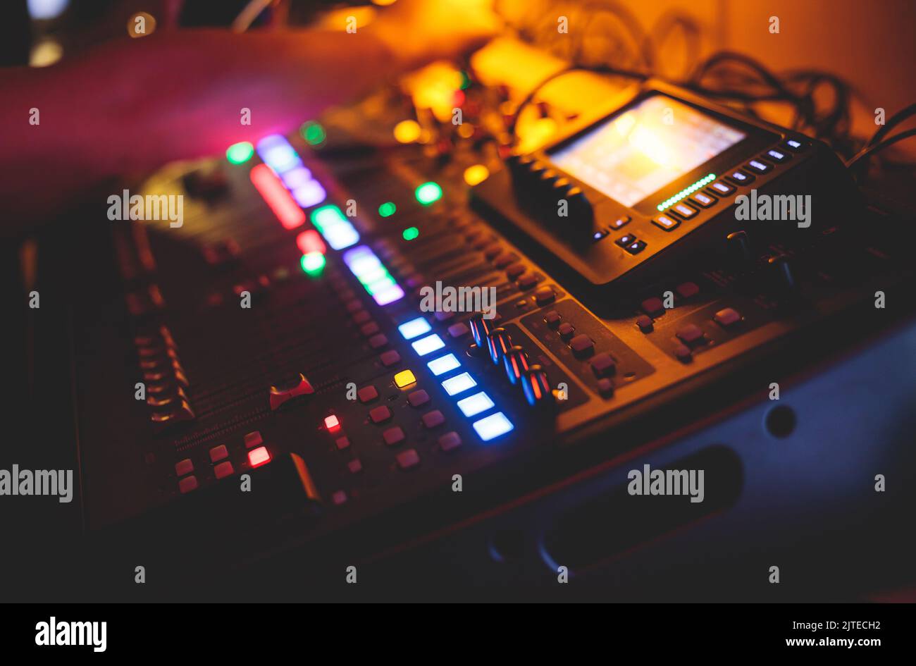 View of lighting technician operator working on mixing console ...