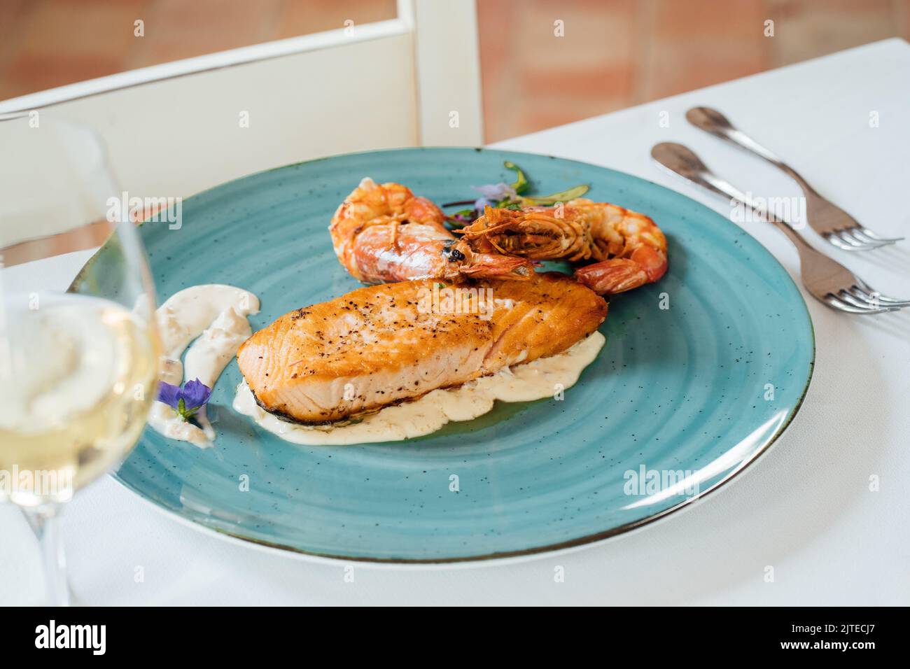 The high-angle view of grilled salmon and shrimp served on the blue plate Stock Photo