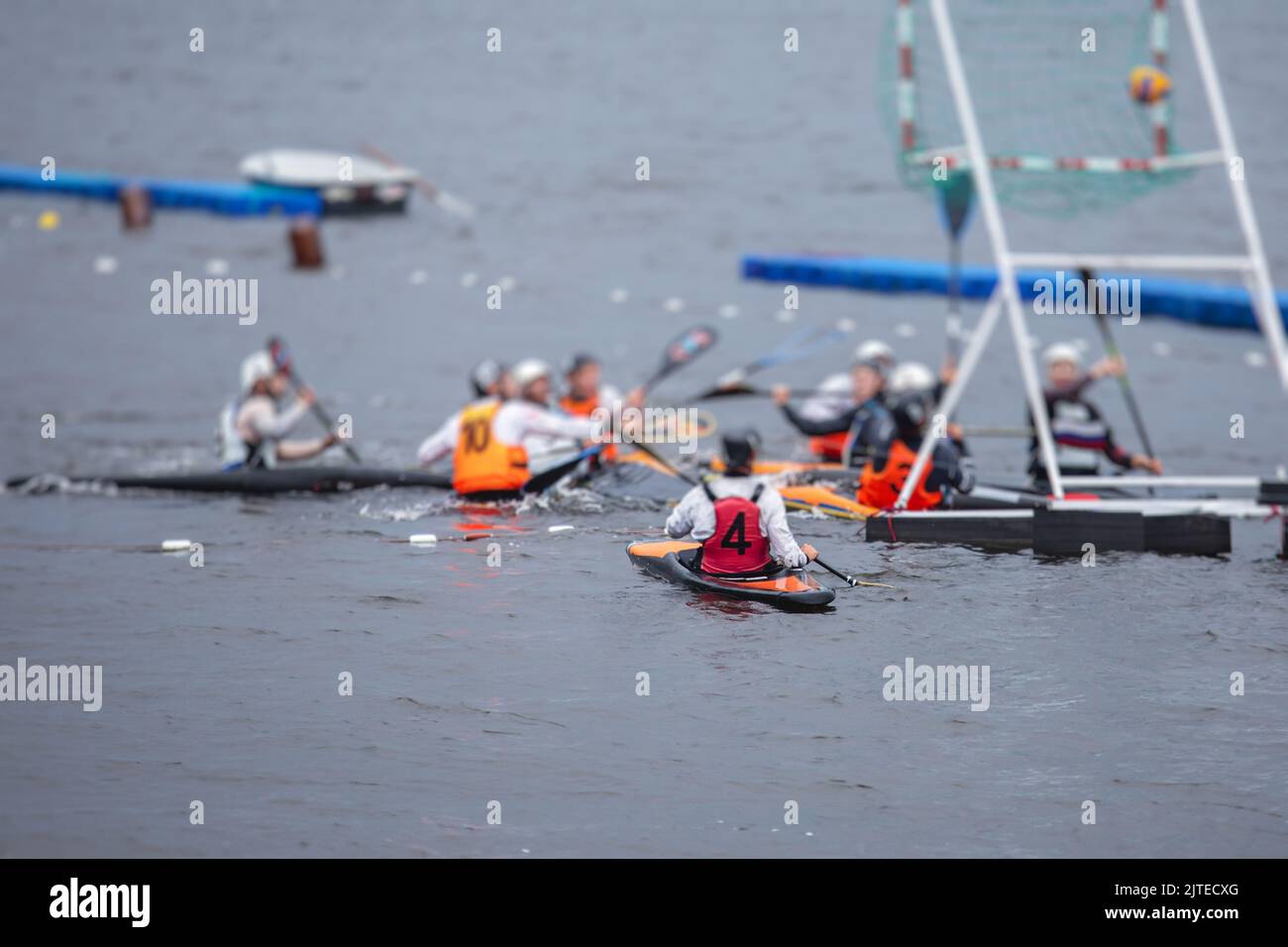 Canoe polo match, two teams play kayak polo game outdoor competition in
