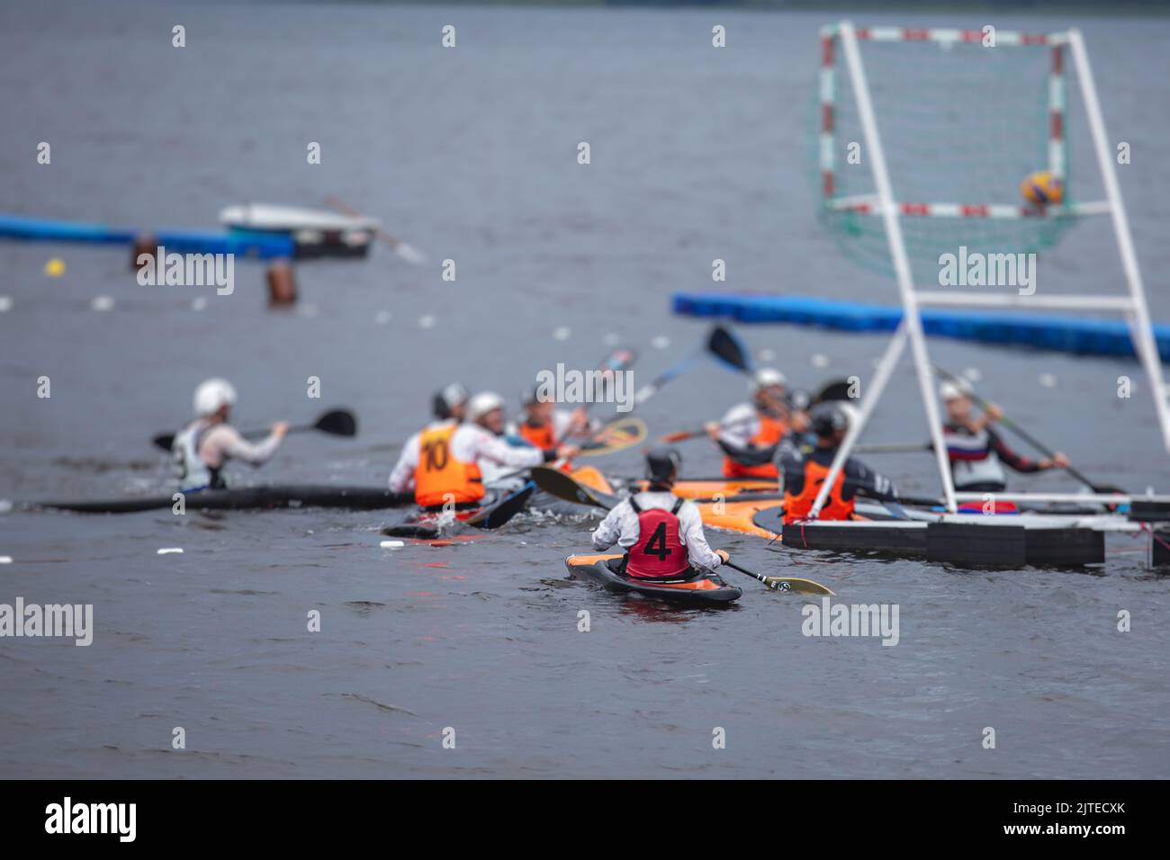 Canoe polo match, two teams play kayak polo game outdoor competition in