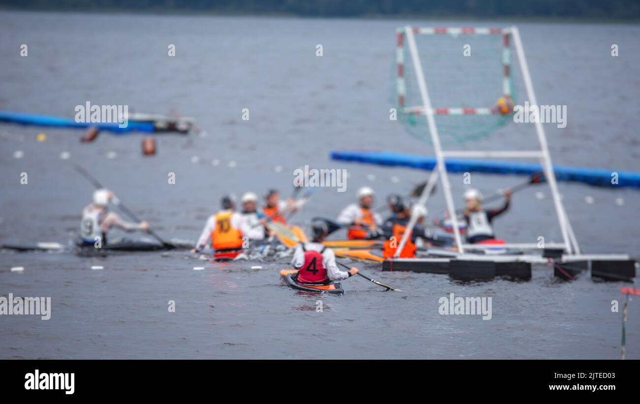Canoe polo match, two teams play kayak polo game outdoor competition in