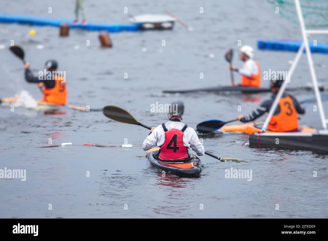 Canoe polo match, two teams play kayak polo game outdoor competition in