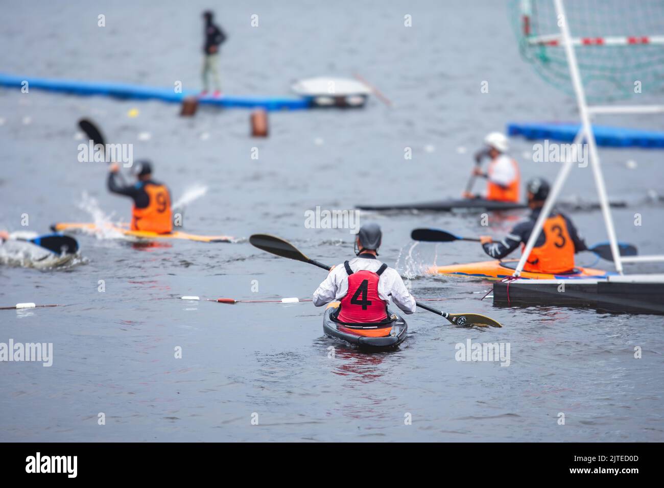 Canoe polo match, two teams play kayak polo game outdoor competition in