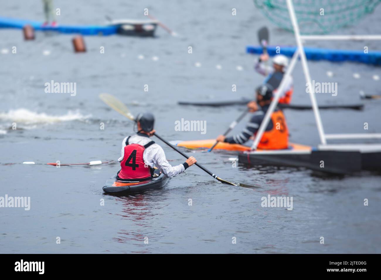 Canoe polo match, two teams play kayak polo game outdoor competition in