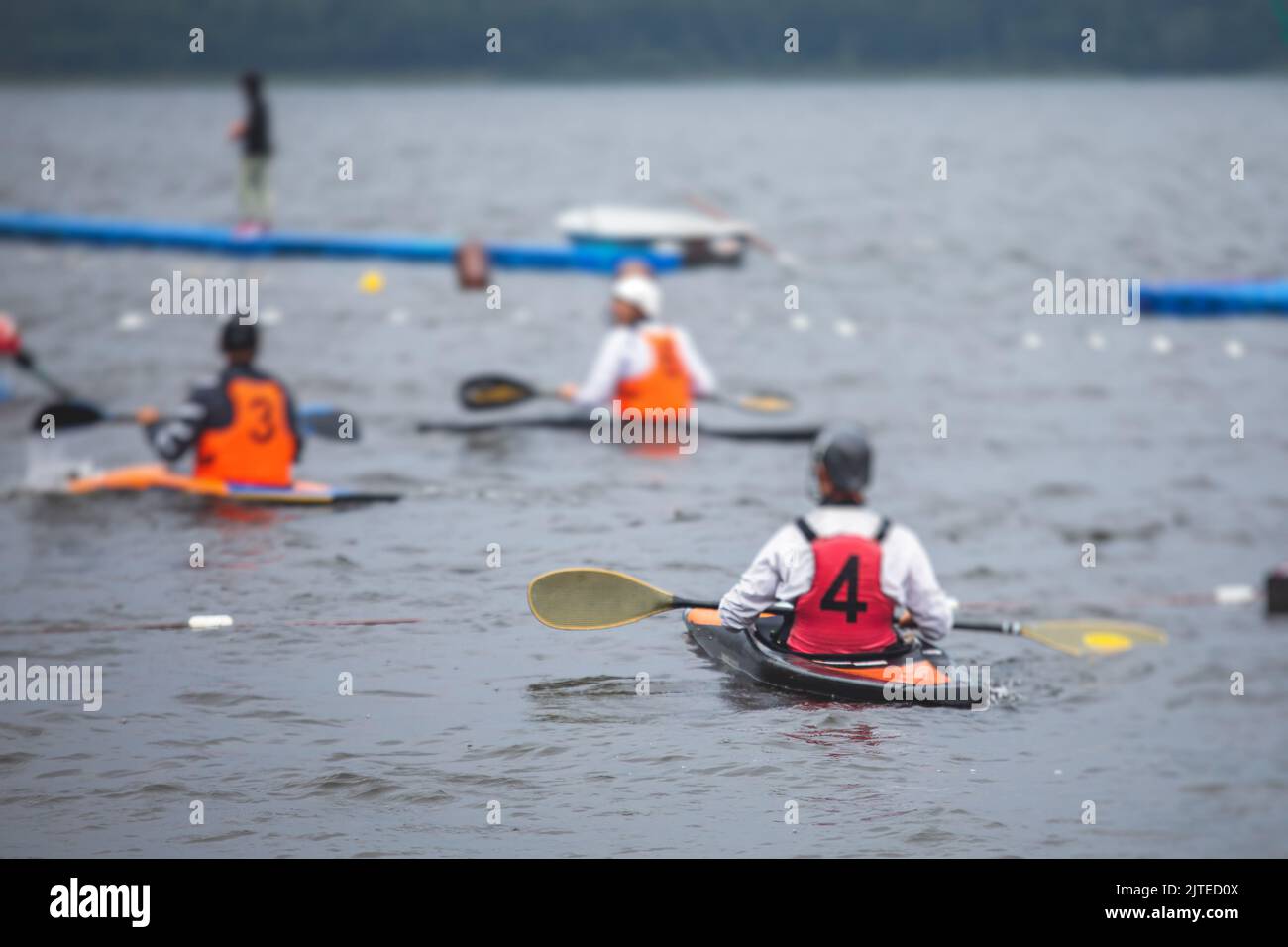 Canoe polo match, two teams play kayak polo game outdoor competition in