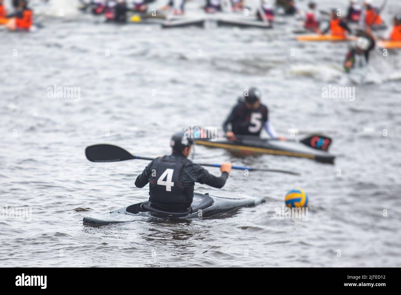 Canoe polo match, two teams play kayak polo game outdoor competition in