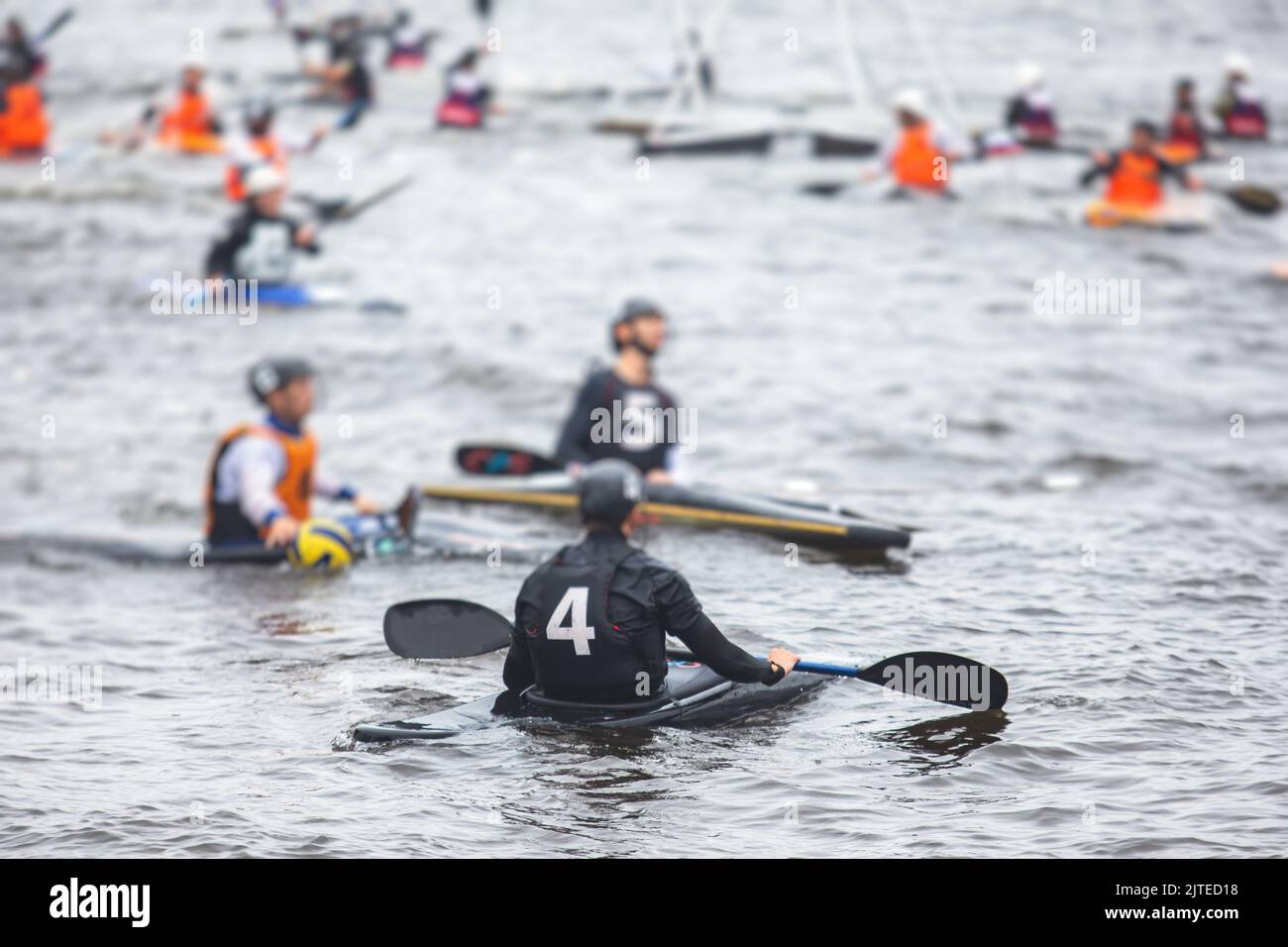 Canoe polo match, two teams play kayak polo game outdoor competition in