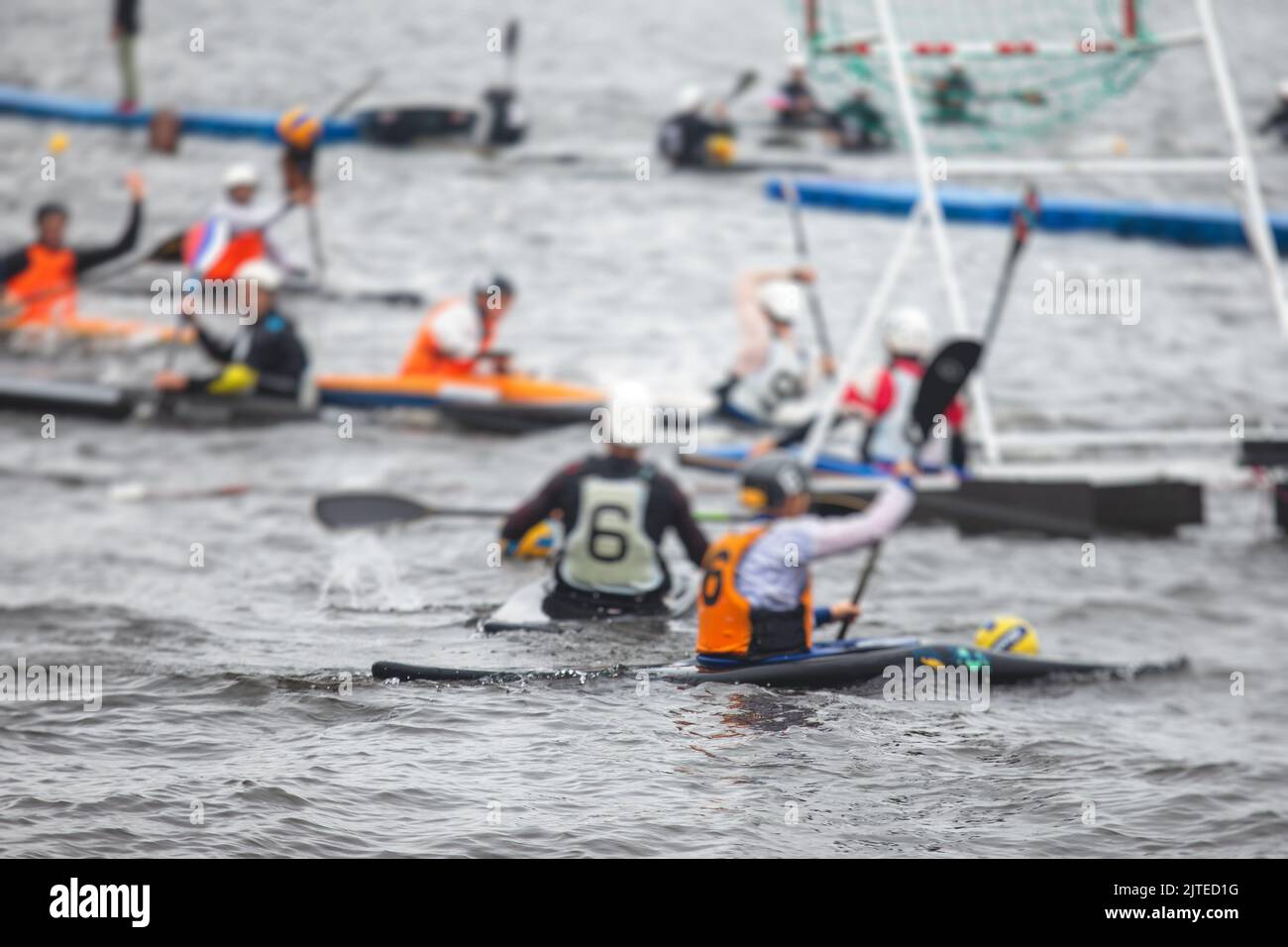 Canoe polo match, two teams play kayak polo game outdoor competition in