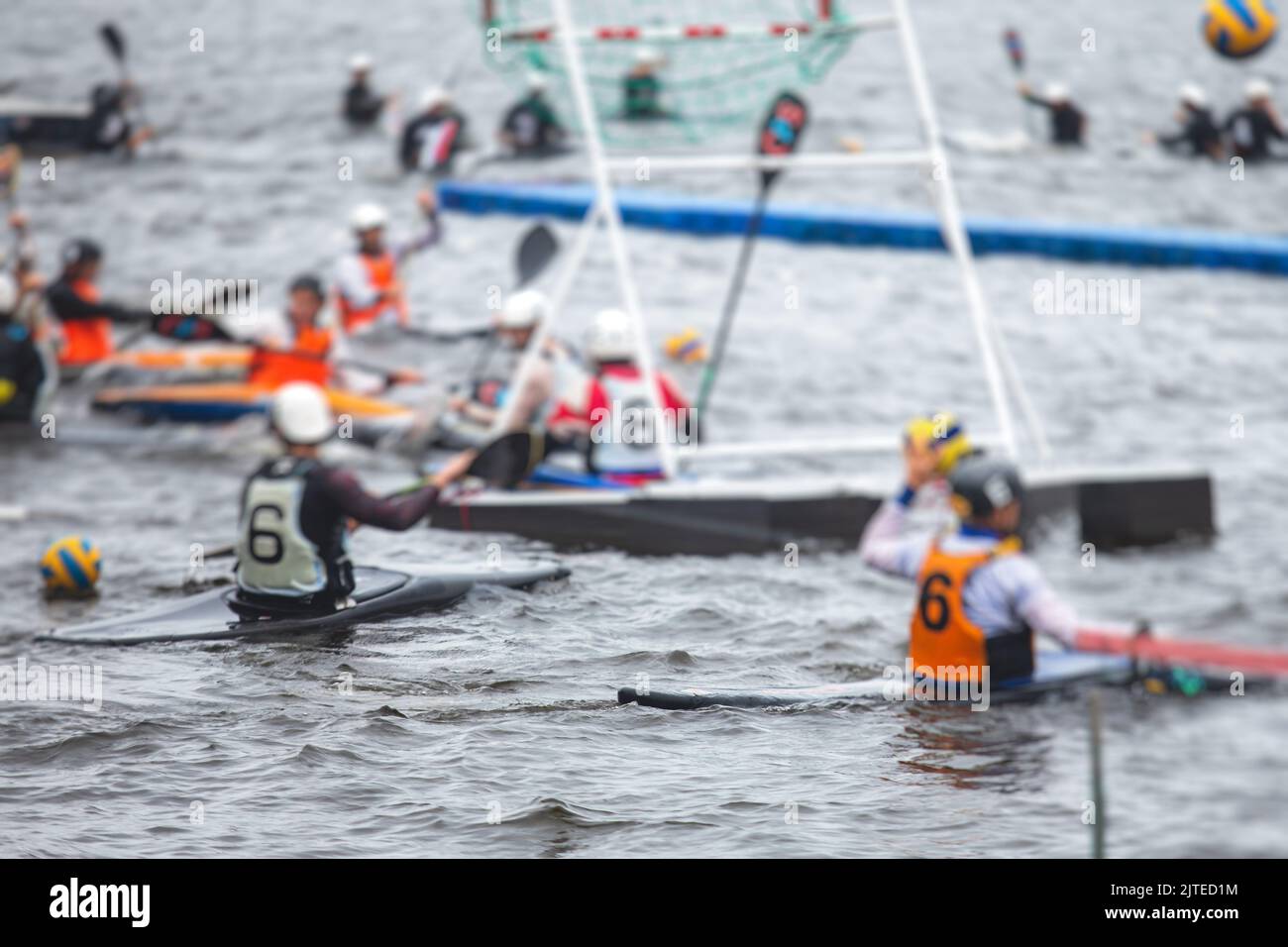 Canoe polo match, two teams play kayak polo game outdoor competition in