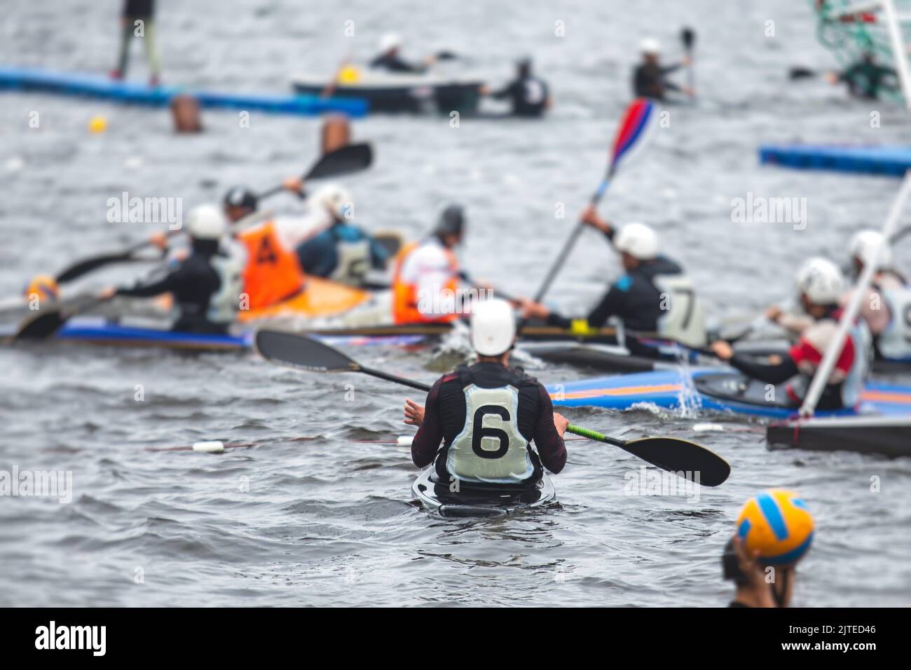 Canoe polo match, two teams play kayak polo game outdoor competition in