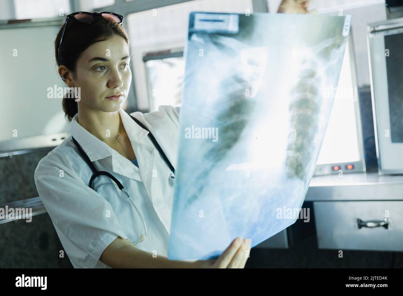 Female doctor check on scan results on monitors in laboratory Stock Photo