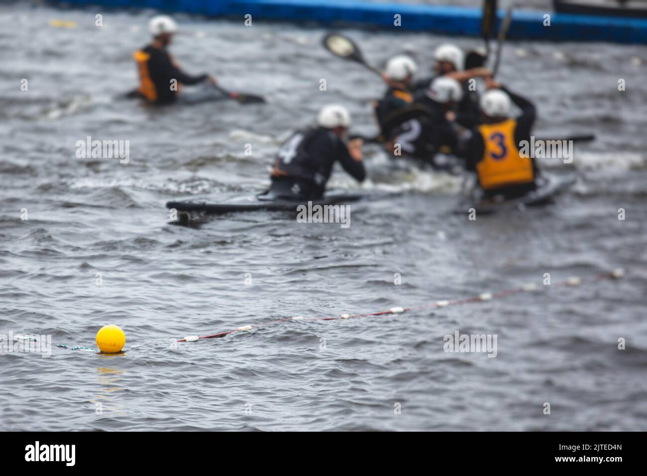 Canoe polo match, two teams play kayak polo game outdoor competition in