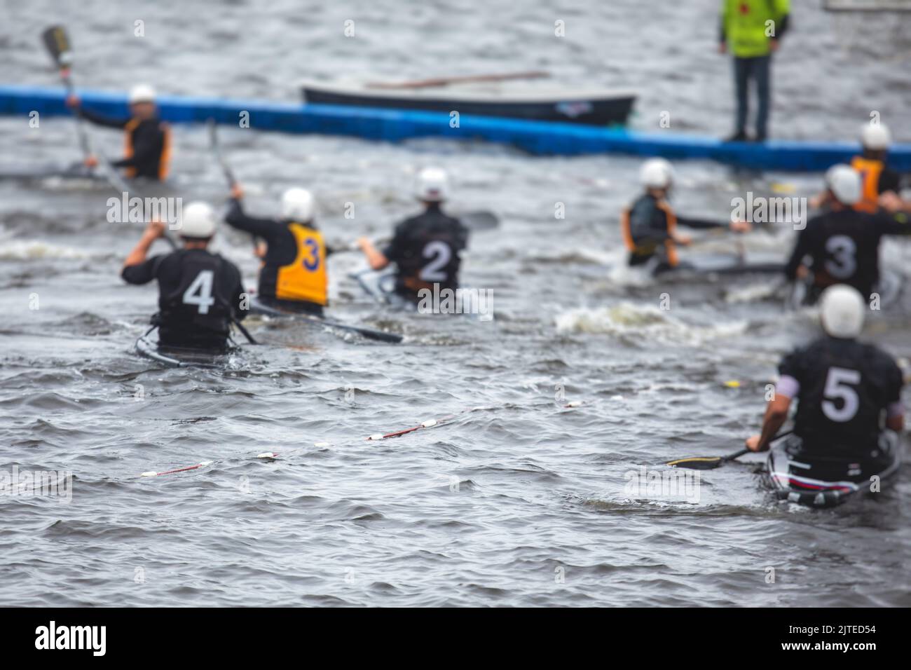 Canoe polo match, two teams play kayak polo game outdoor competition in
