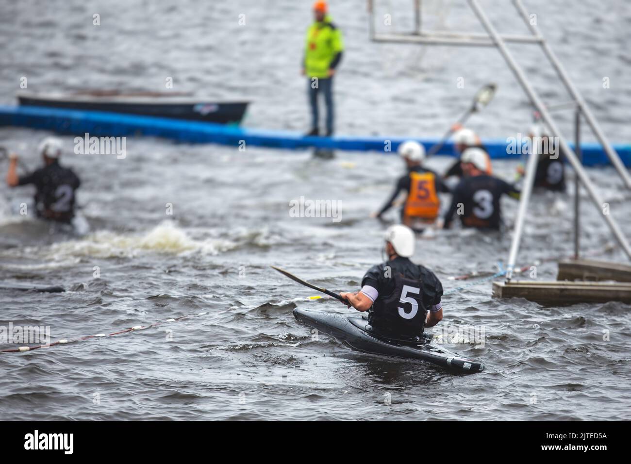 Canoe polo match, two teams play kayak polo game outdoor competition in