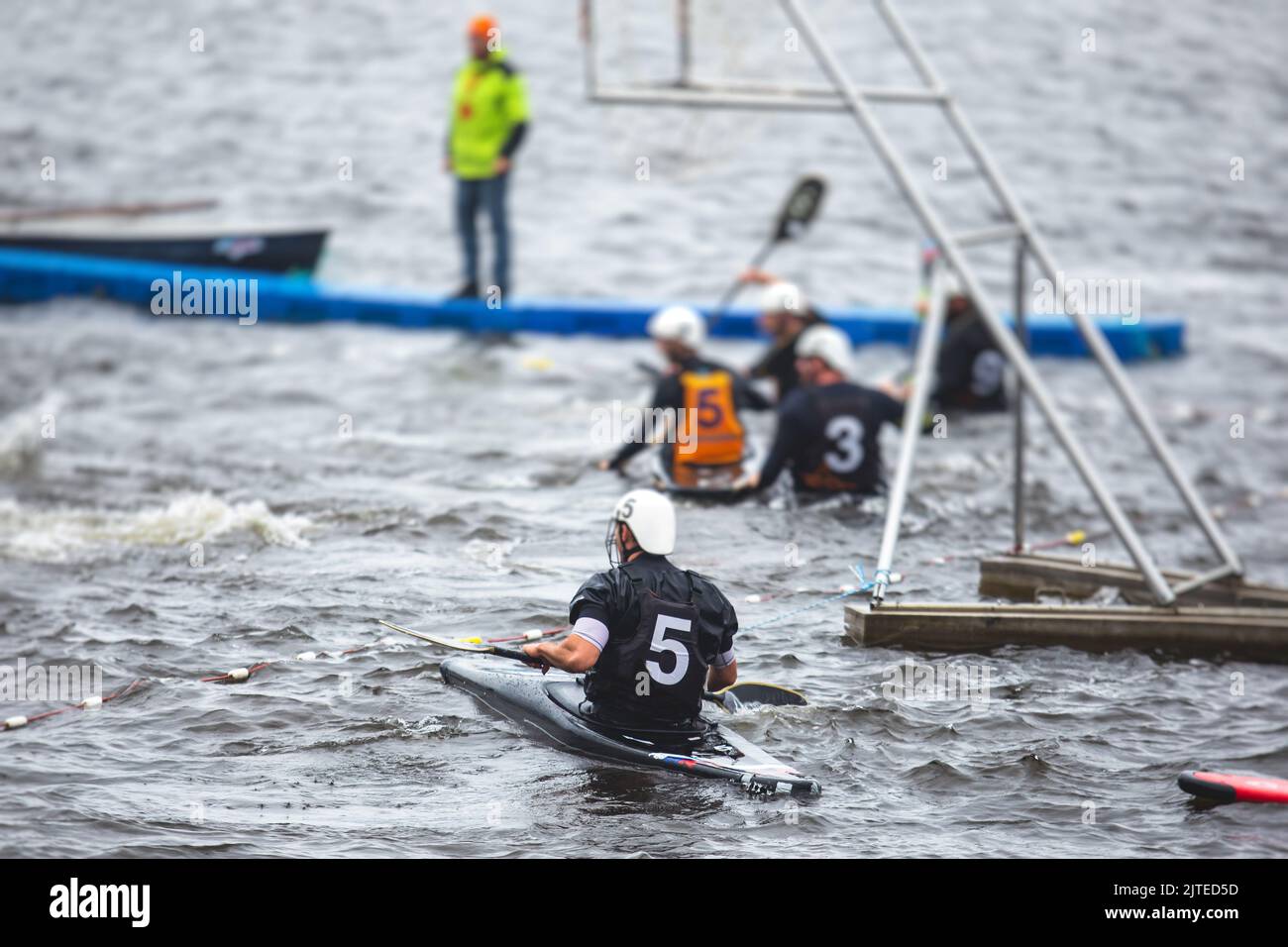 Canoe polo match, two teams play kayak polo game outdoor competition in