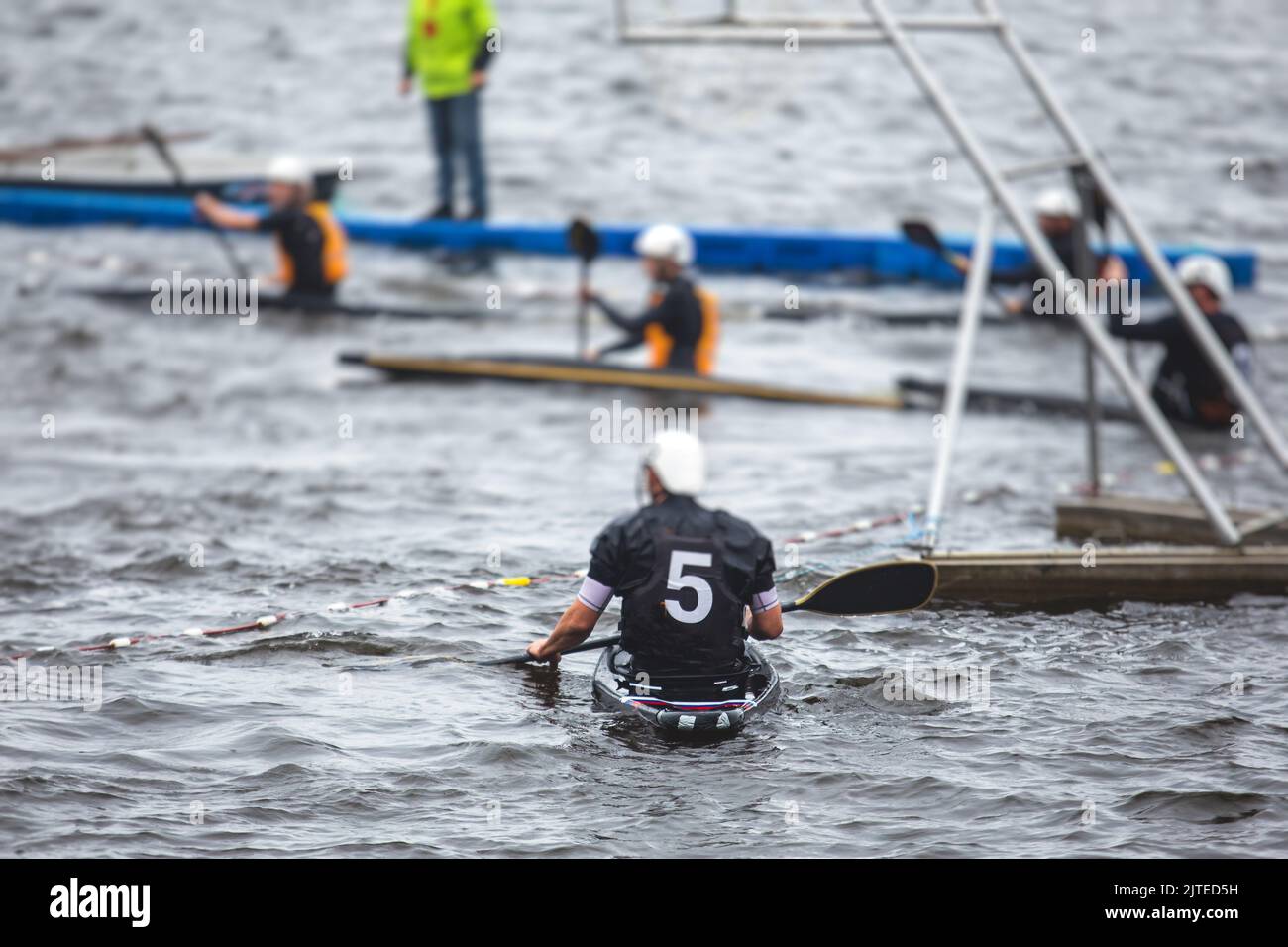 Canoe polo match, two teams play kayak polo game outdoor competition in