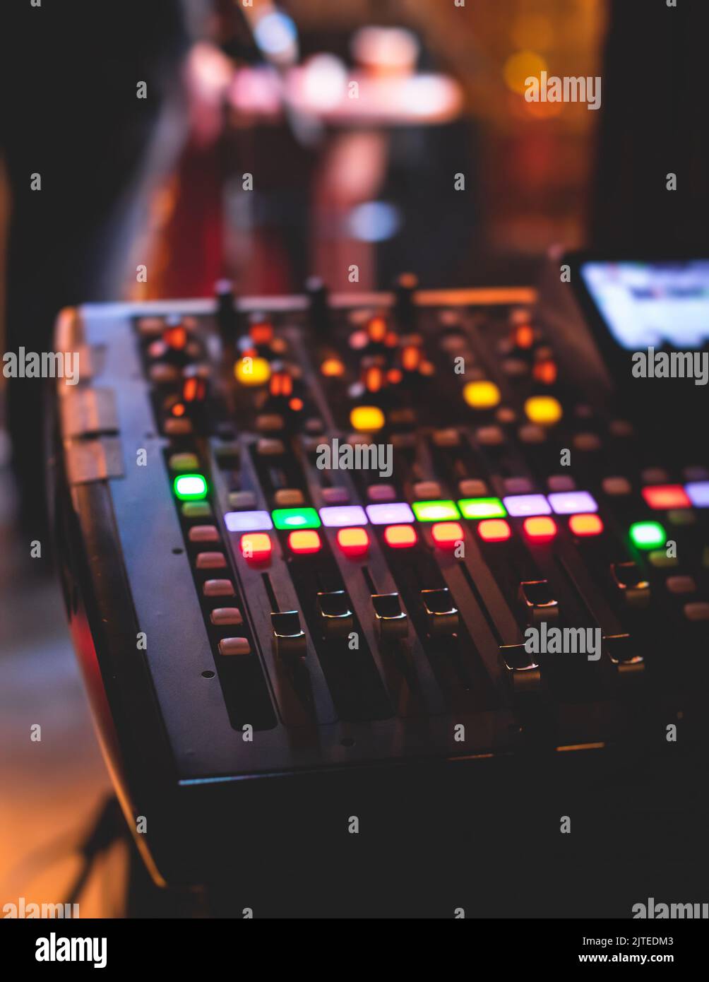 View of lighting technician operator working on mixing console