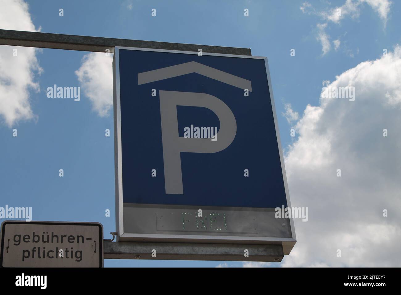 A blue Parking sign against a blue cloudy sky Stock Photo - Alamy