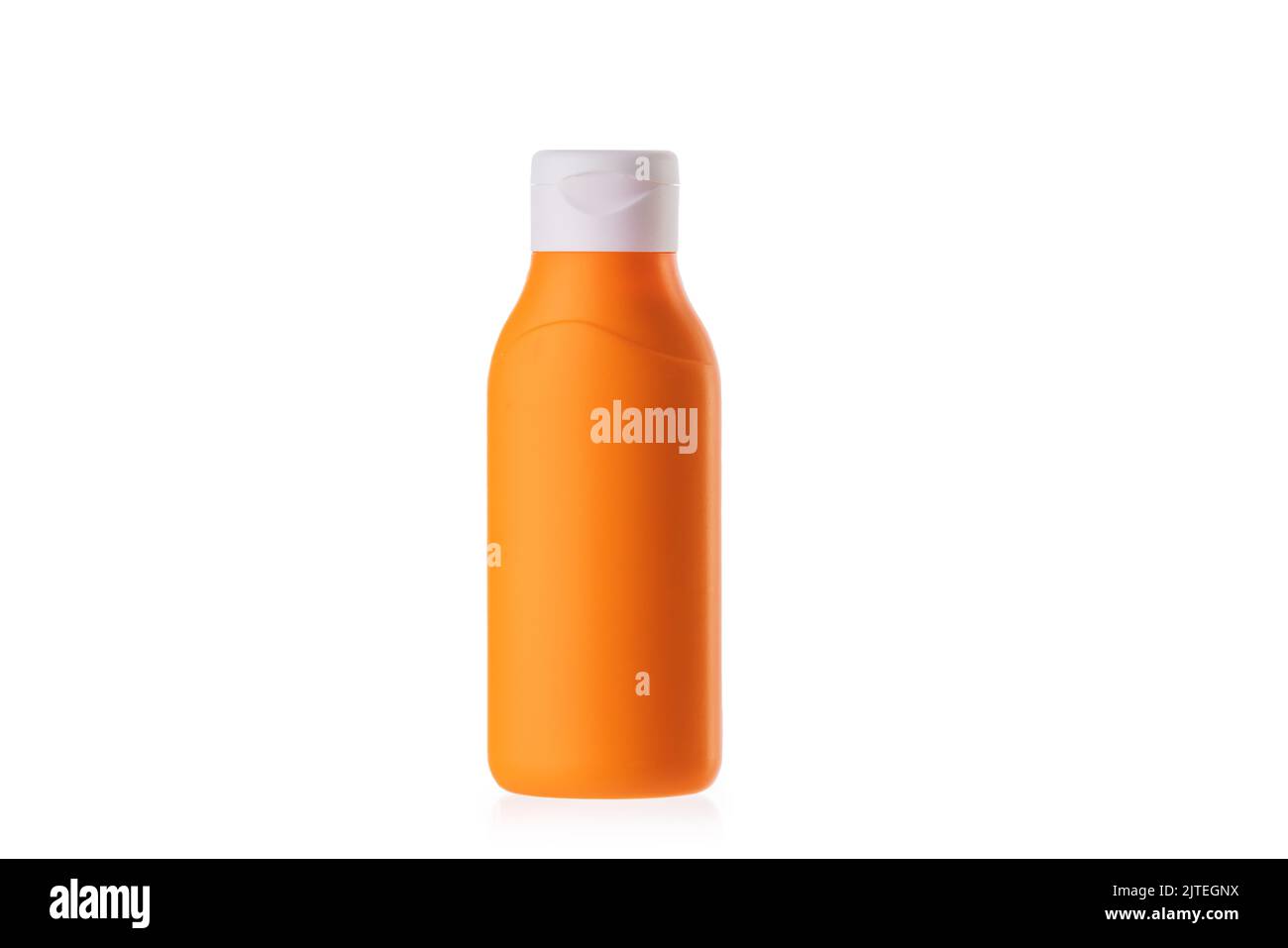 Sun cream lotion in orange bottle isolated on white background. Sunscreen milk bodycare, skincare. Stock Photo