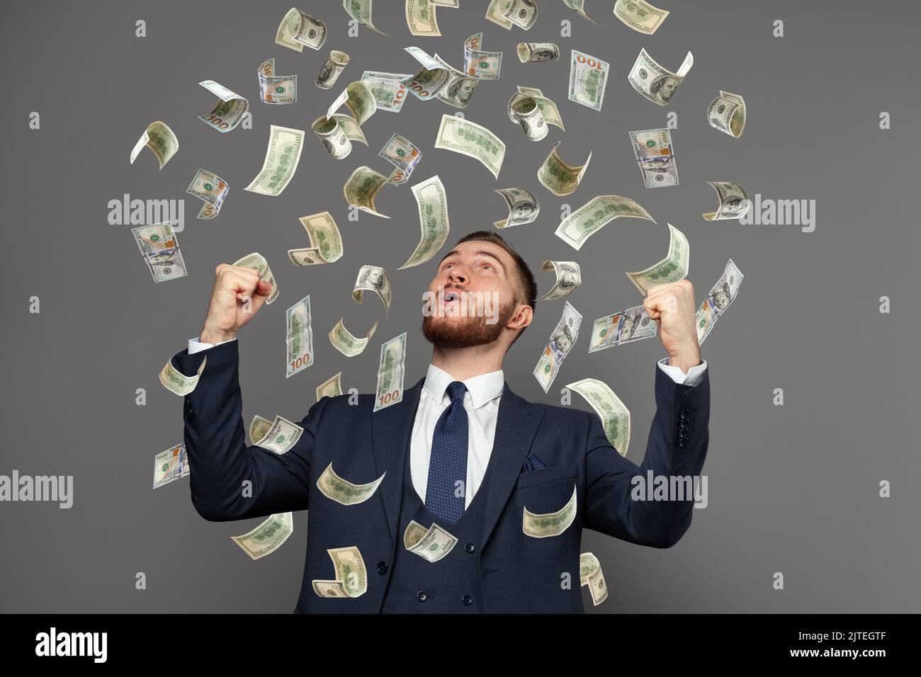 Happy business man very rich guy with money dollar bills in air like