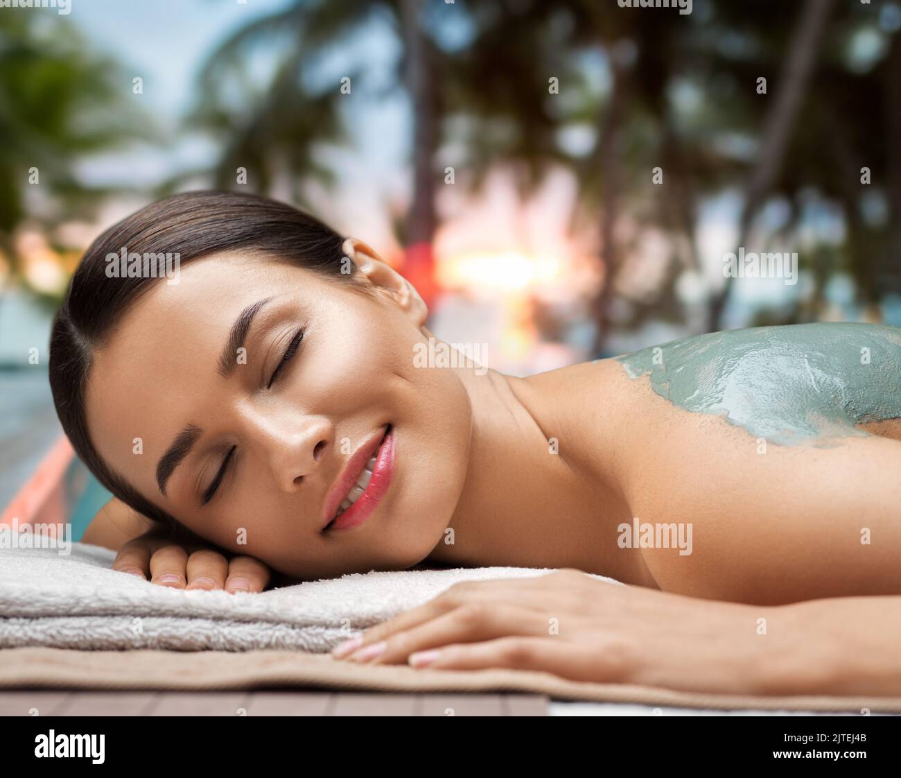 woman with blue clay mask in spa Stock Photo