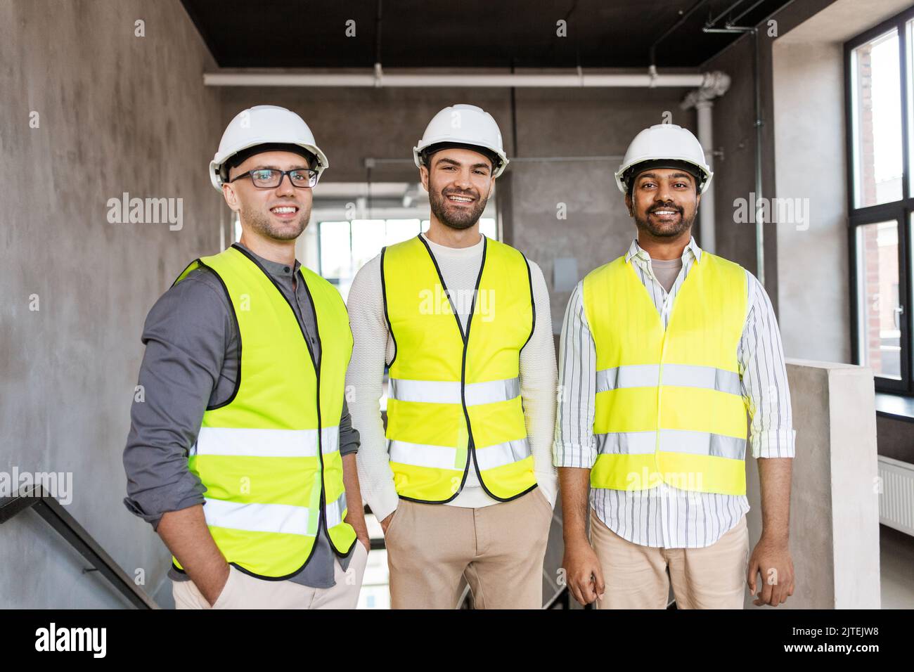 happy smiling male architects in helmets at office Stock Photo