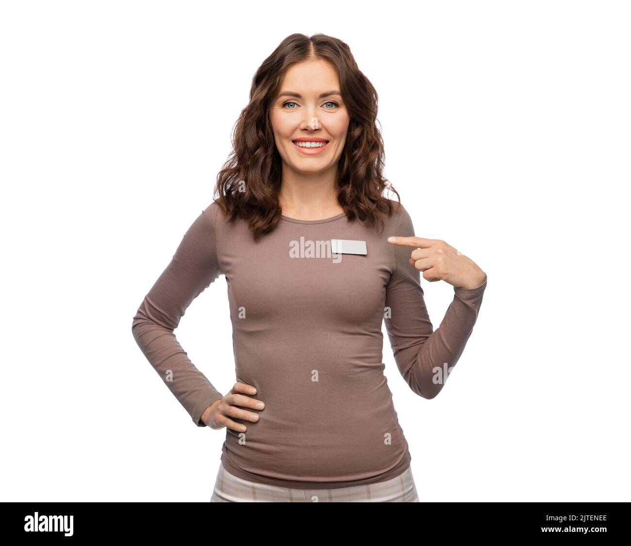 happy female shop assistant showing her name tag Stock Photo - Alamy