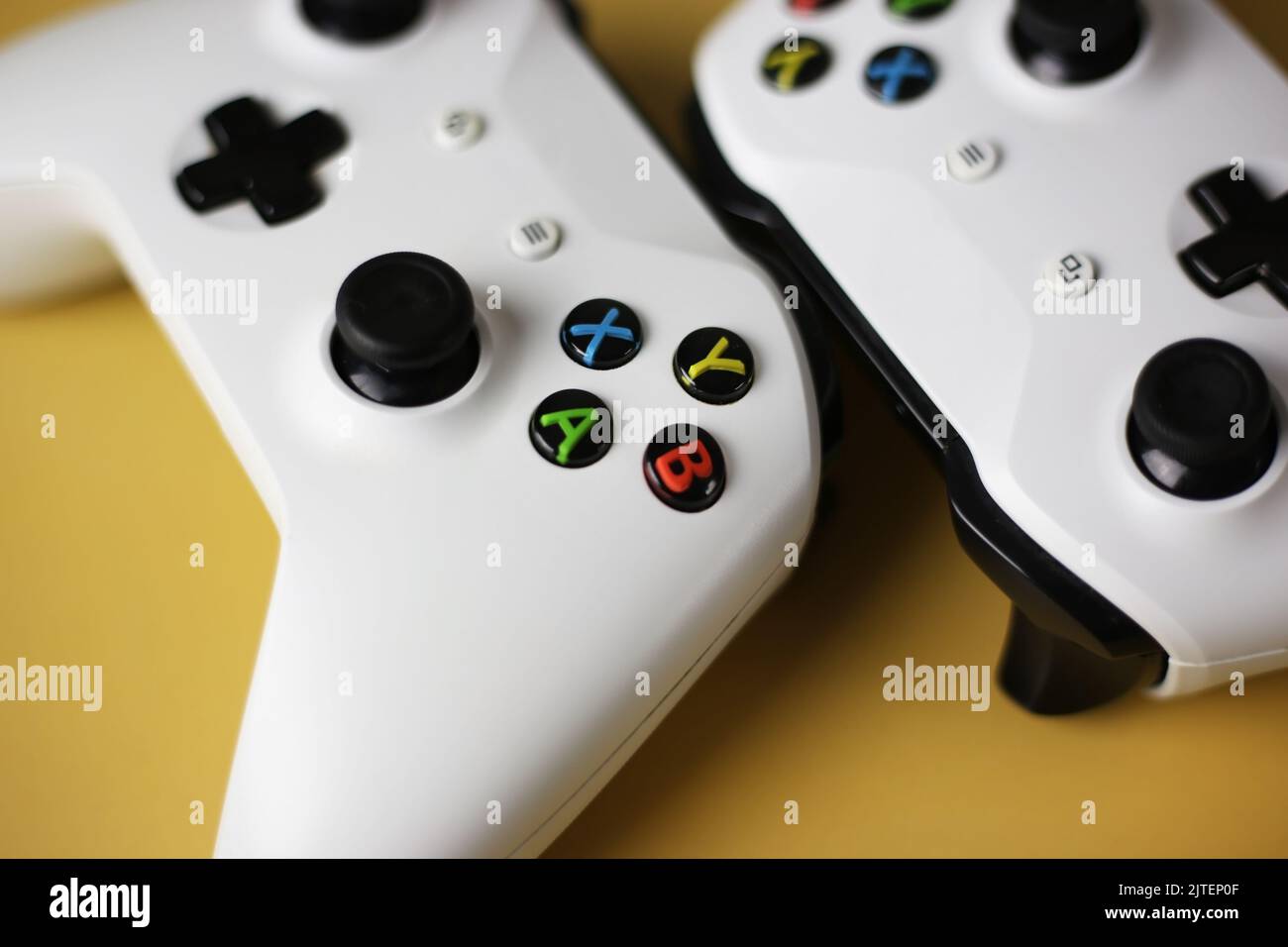 Two gaming gamepad buttons closeup on a yellow background Stock Photo