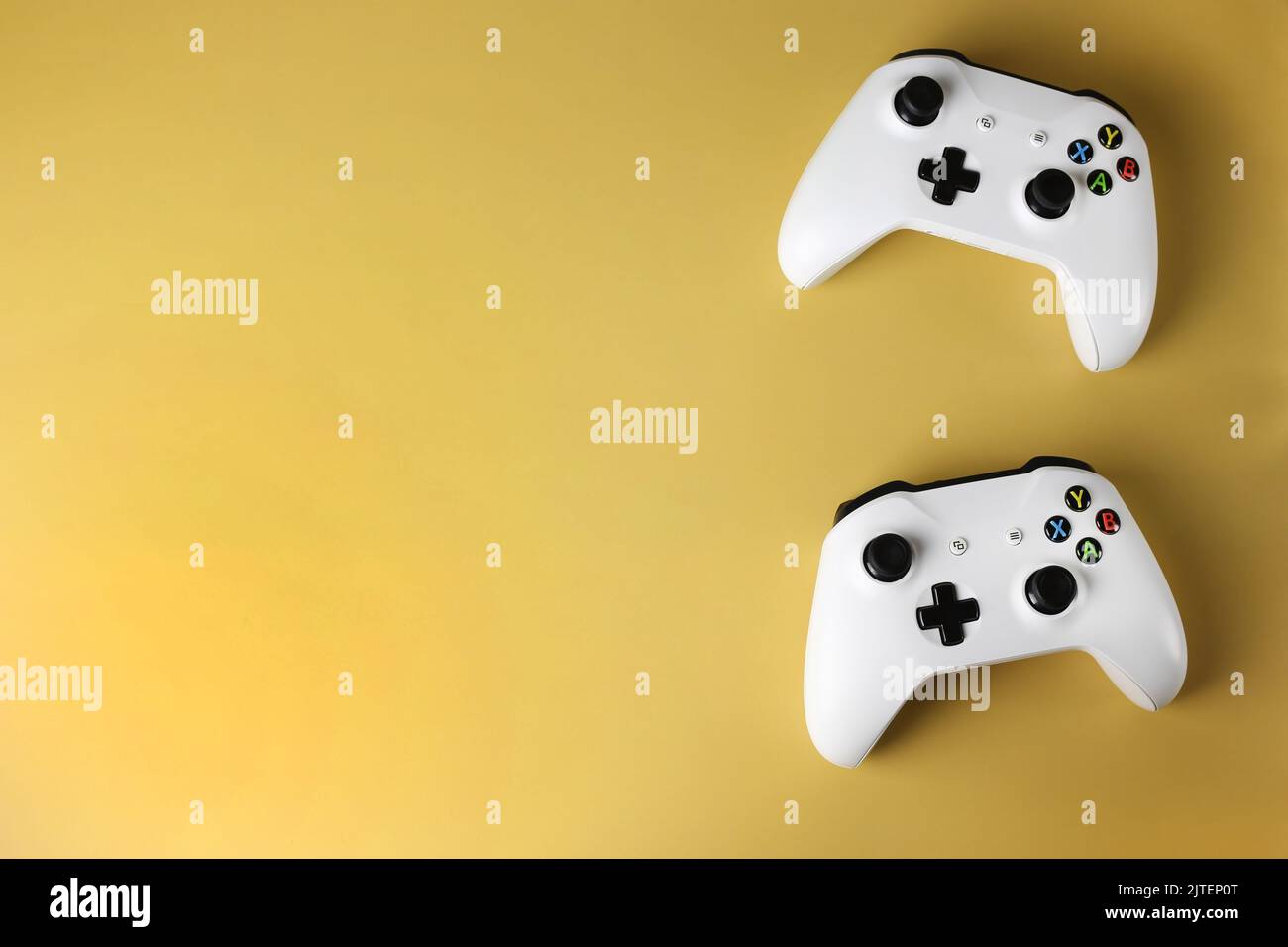 Two gaming gamepads on the side on an isolated yellow background Stock ...