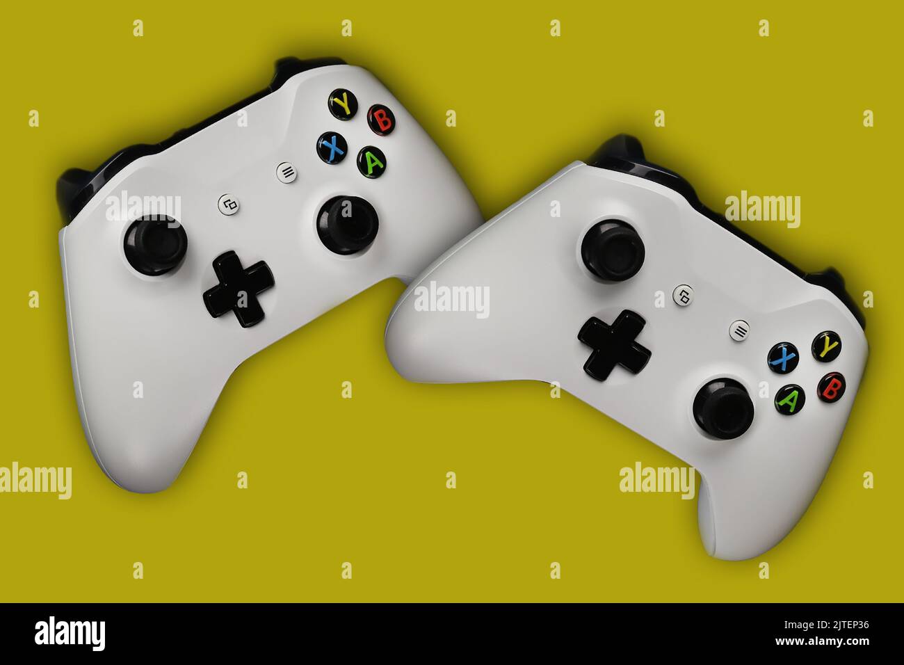 Two gaming gamepads in flight on an isolated yellow background Stock ...