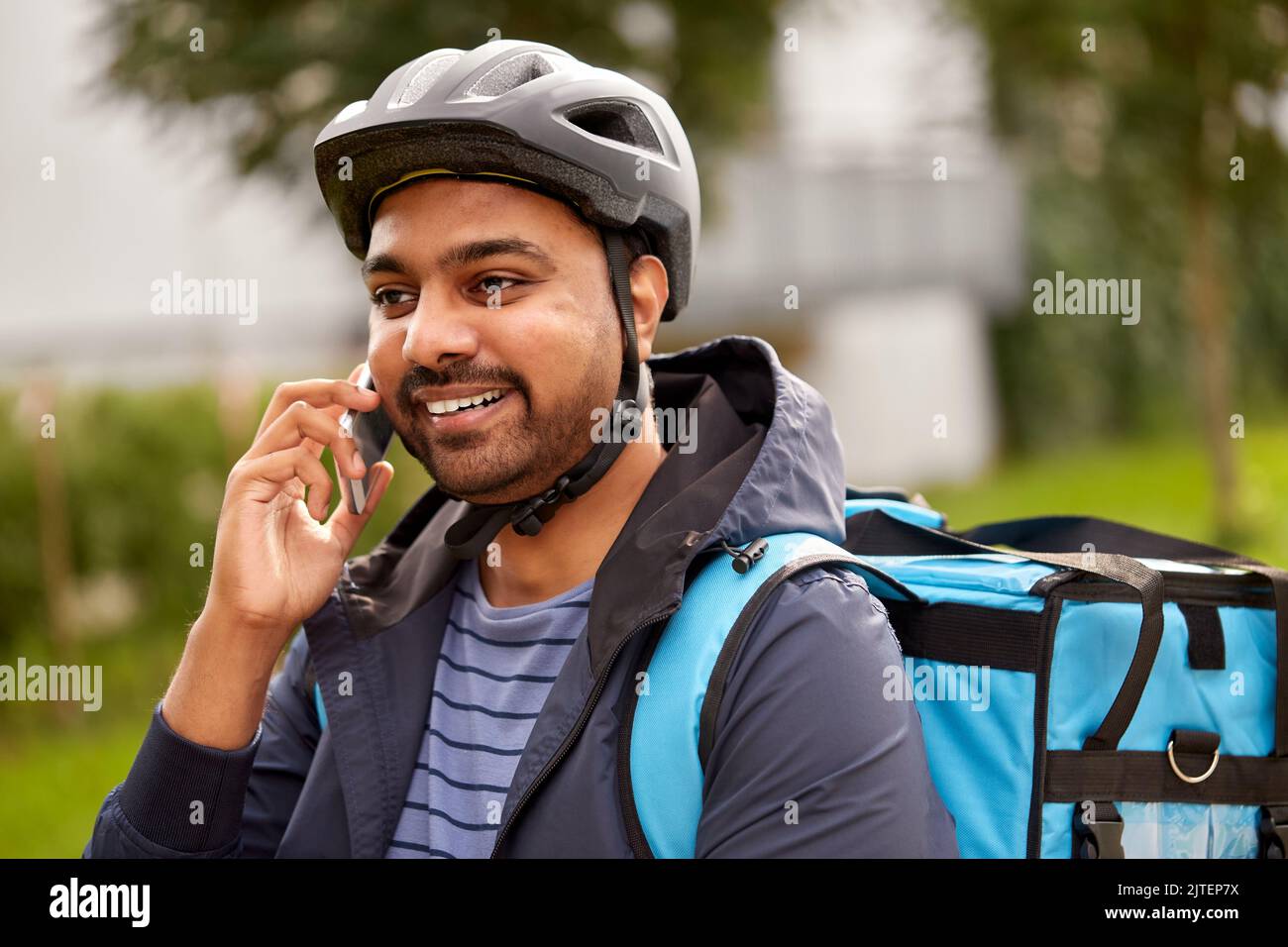 food delivery man with bag calling on smartphone Stock Photo Alamy